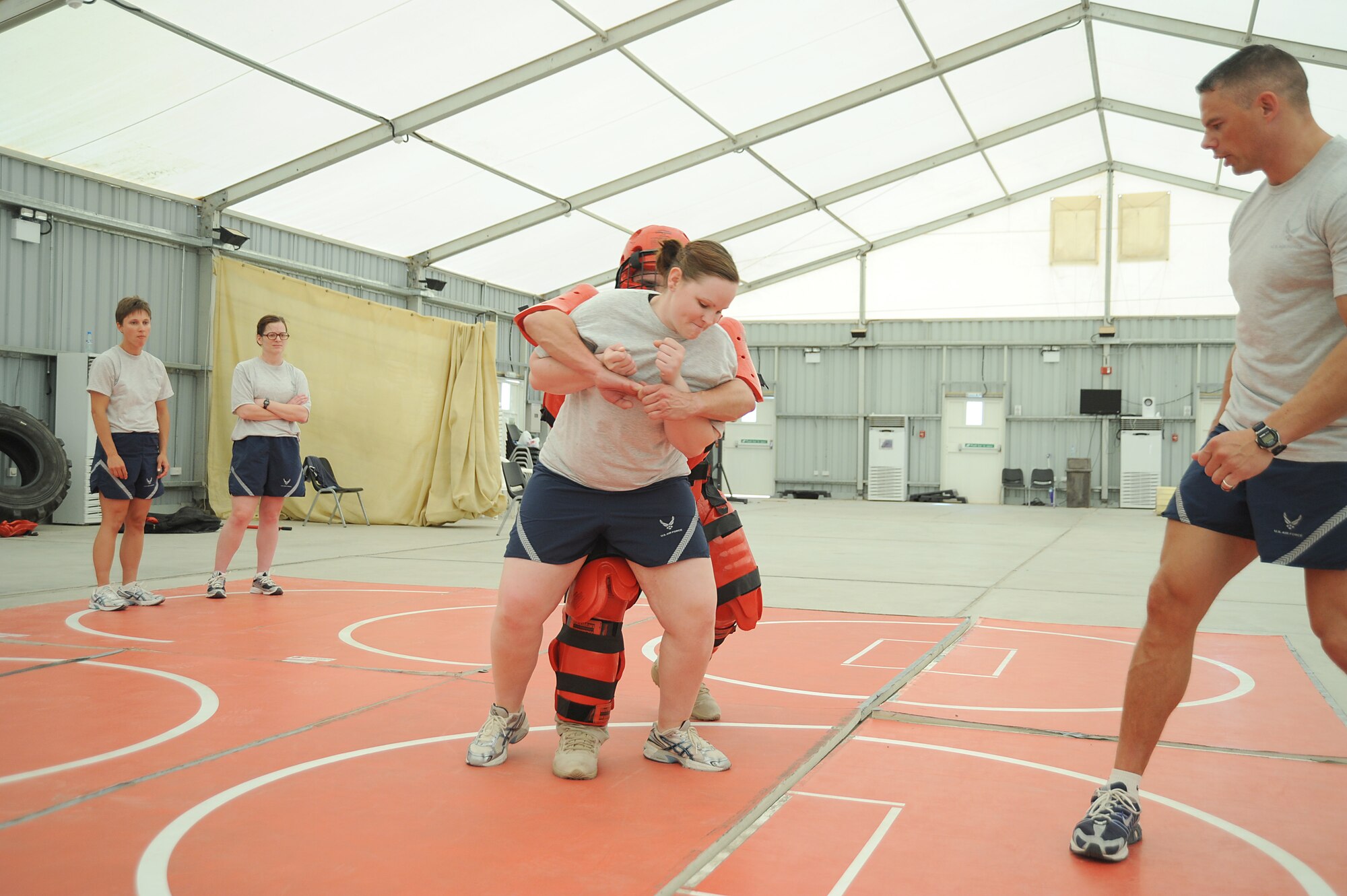 Airman 1st Class Amanda Dunaway, 380th Expeditionary Security Forces Squadron, fights off an attacker played by Mr. Rick Baldwin, a Northrop Grumman contractor during self-defense training, April 18 at an undisclosed location in Southwest Asia. The Sexual Assault Response Coordinator (SARC) sponsored the training that gave students the chance to learn techniques to defend themselves from attack. Airman Dunaway is deployed from Tinker AFB, Okla. and hails from Beaumont, Calif. (U.S. Air Force photo by Senior Airman Brian J. Ellis) (Released)