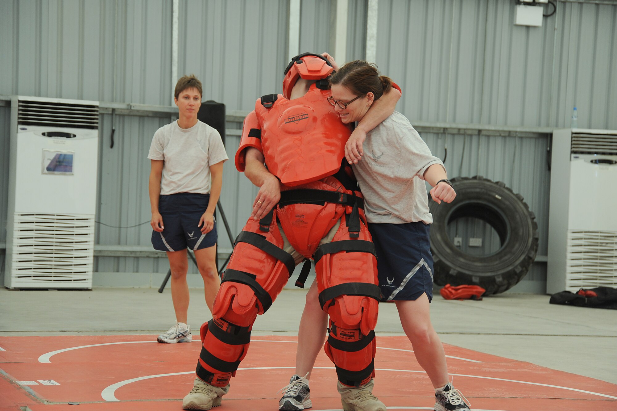 Capt. Kelly McElroy, 380th Expeditionary Communications Squadron, prepares to give a blow to the mid section of Mr. Rick Baldwin, a Northrop Grumman contractor posed as the "red man attacker" during self-defense training, April 18 at an undisclosed location in Southwest Asia. The Sexual Assault Response Coordinator (SARC) sponsored the training that gave students the chance to learn techniques to defend themselves from attack. Captain McElroy is deployed from Lackland AFB, Texas and hails from Jefferson City, Mo. (U.S. Air Force photo by Senior Airman Brian J. Ellis) (Released)