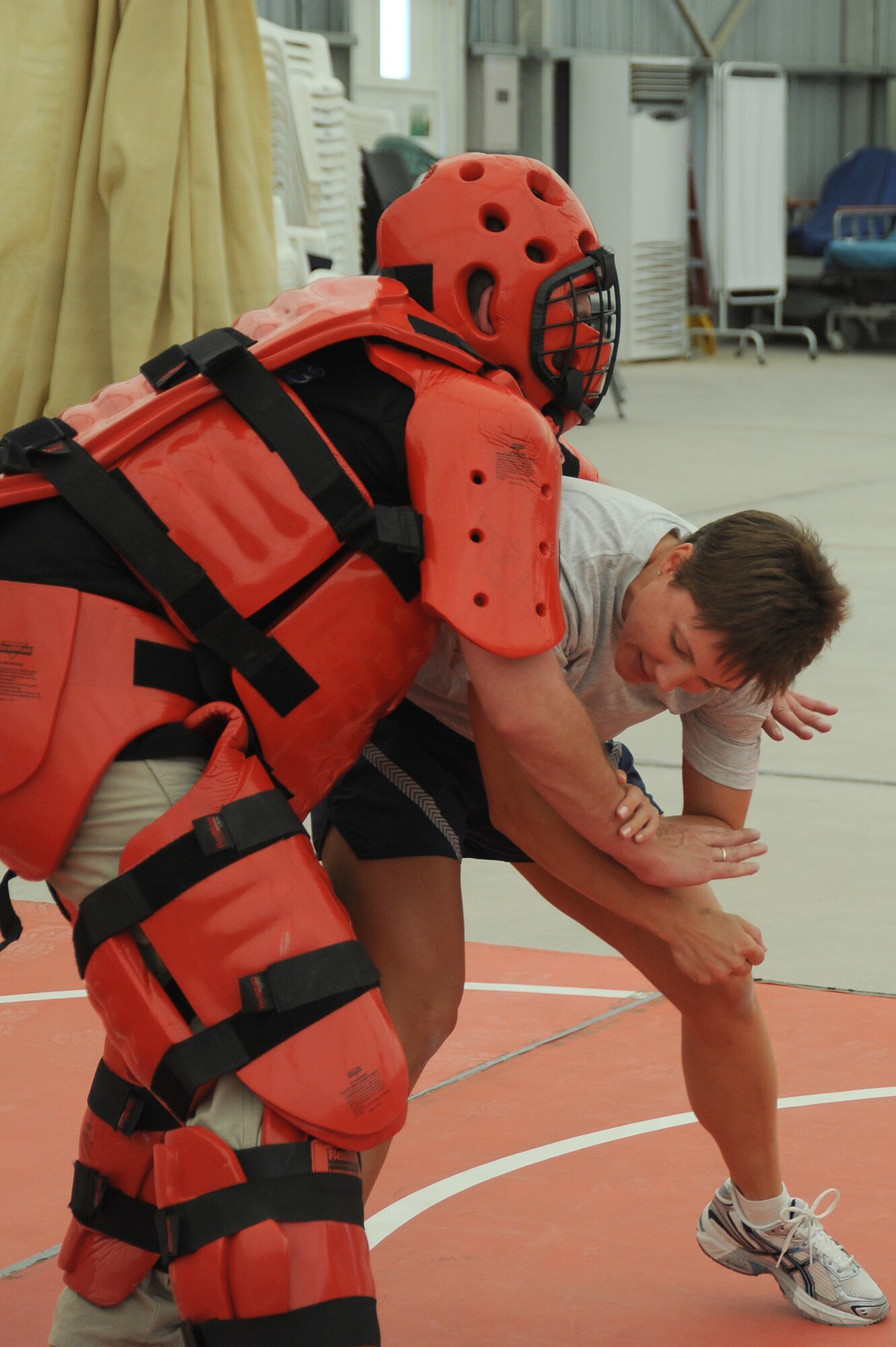 Master Sgt. Malinda Kingsley, 380th Expeditionary Maintenance Squadron, fights off an attacker played by Mr. Rick Baldwin, a Northrop Grumman contractor during self-defense training, April 18 at an undisclosed location in Southwest Asia. The Sexual Assault Response Coordinator (SARC) sponsored the training that gave students the chance to learn techniques to defend themselves from attack. Sergeant Kingley is deployed from Grand Forks AFB, N.D. and hails from Morgan, Minn. (U.S. Air Force photo by Senior Airman Brian J. Ellis) (Released)