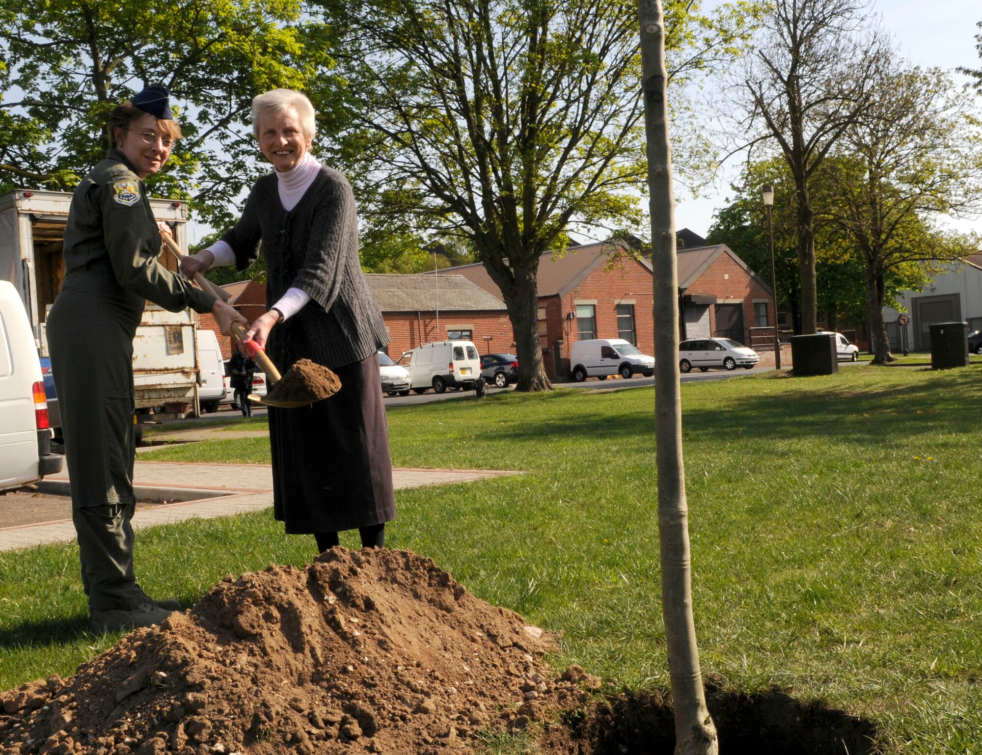 Colonel Eden J. Murrie, 100th Air Refueling Wing Commander, and Faith Rutheford from the 100th Civil Engineering Squadron, plant a tree to honor earth week on RAF Mildenhall, April 23.  Several trees were planted in addition to many other events done to show the U.S. Air Force's commitment to preserving the environment.  (U.S. Air Force photo by Senior Airman Christopher L. Ingersoll)