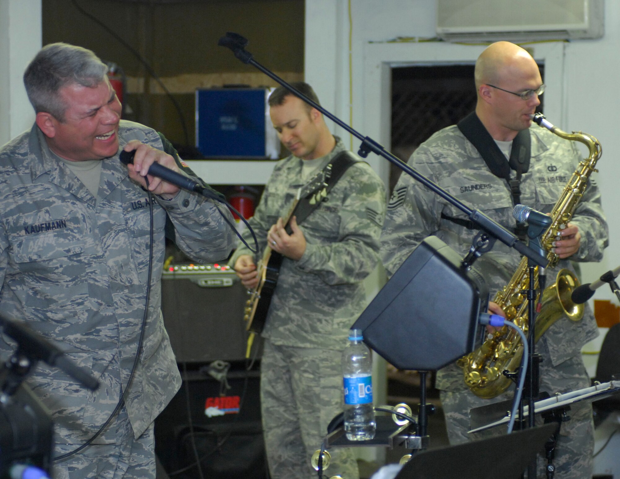Master Sgt. William Kaufmann, 455th Expeditionary Civil Engineer Squadron, sings a rendition of ?Mustang Sally? as a guest performer in the Sirocco band at Bagram Air Field, Afghanistan, April 20. In each visit, the band tries to find local talent at the base to incorporate in the performance. Sergeant Kaufmann has been deployed to four bases in 12 months to Southwest Asia. He is deployed from Selfridge Air National Guard, Mich., and hales from Detroit, Mich. (U.S. Air Force photo/ Senior Airman Erik Cardenas)(Released)