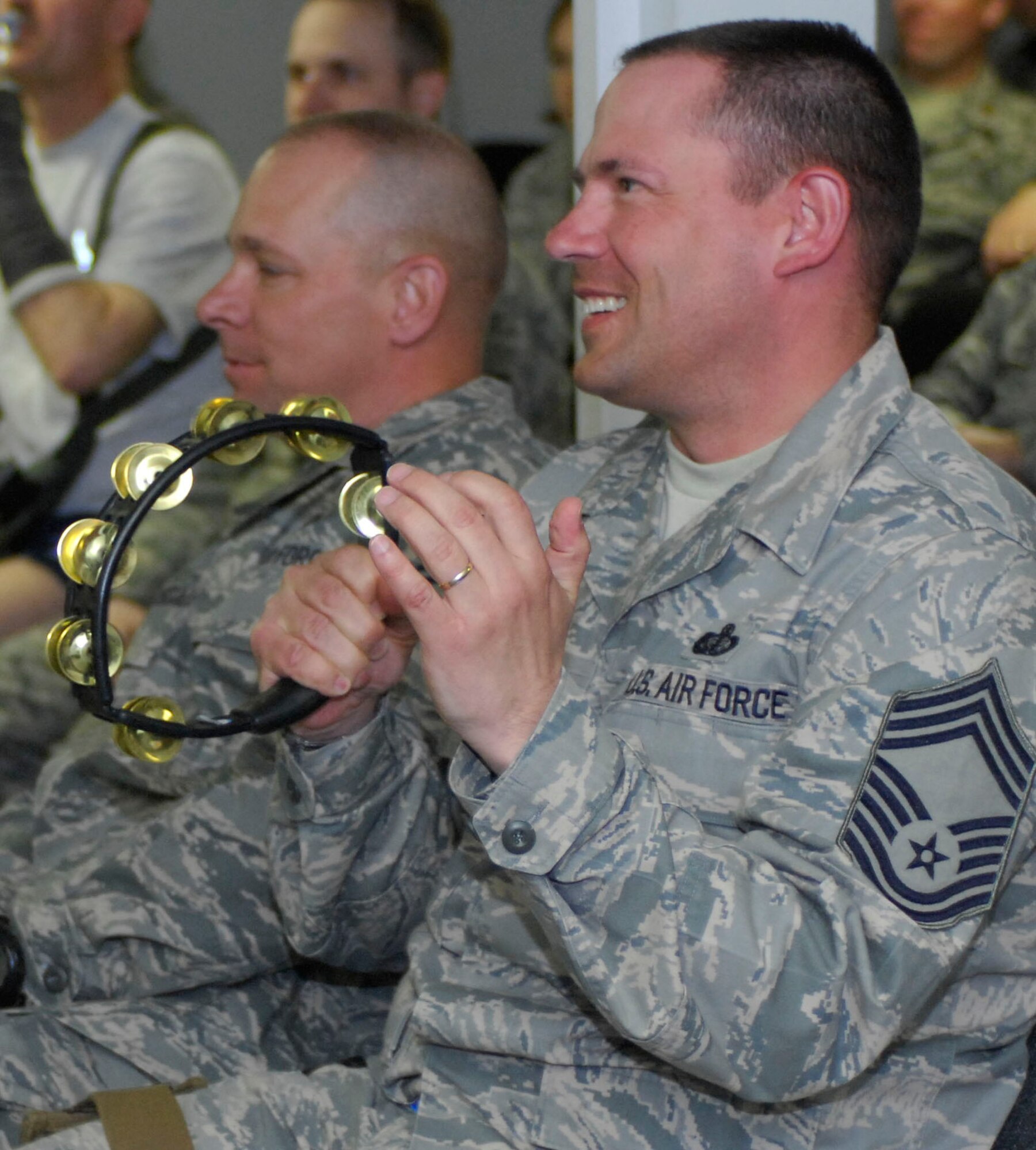 Chief Master Sgt. Patrick Fry, 455th Expedtionary Force Support Squadron, plays the tambourine for the Sirocco band at Bagram Air Field, Afghanistan, April 20. The band incorporates audience participation to keep an upbeat atmosphere. The U.S. Air Forces Central Expeditionary Band is deployed to Southwest Asia from the U.S. Air Forces in Europe Band at Sembach Air Base, Germany. Chief Fry is deployed from Ramstein Air Base, Germany, and hales from Houston, Texas. (U.S. Air Force photo/ Senior Airman Erik Cardenas)(Released)