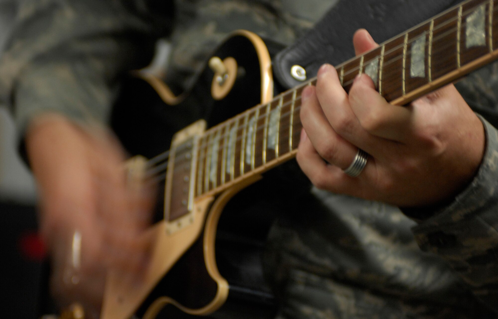 Staff Sgt. Gene Dooley, guitarist for the Sirocco band, strums the guitar for U.S. and coalition servicemembers at Bagram Air Field, Afghanistan, April 20. The U.S. Air Forces Central Expeditionary Band is deployed to Southwest Asia from the U.S. Air Forces in Europe Band at Sembach Air Base, Germany. Sergeant Dooley hales from Graham, Texas. (U.S. Air Force photo/ Senior Airman Erik Cardenas)(Released)