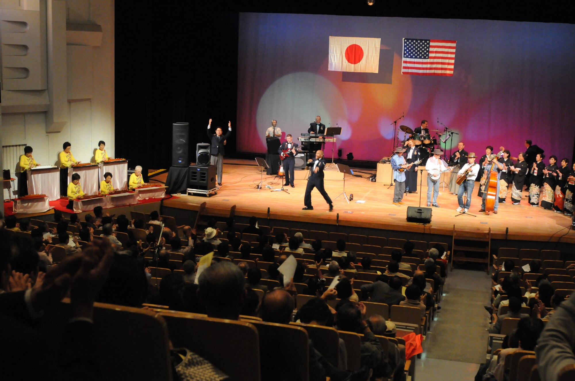 OGAKI CITY, Japan -- Staff Sgt. Josh Holdridge, U. S. Air Force Band of the Pacific-Asia, performs with a taisho-goto or pedal-steel guitar group, tsugaru-shamisen or three-string banjo players and a blue grass band April 20 during a performance here. Airmen from the band based at Yokota often participate in joint musical performances with traditional and contemporary Japanese musical performers. The combined musical events further American and Japanese friendship by communicating through the universal language of music. (U.S. Air Force photo/Tech. Sgt. Kimberly Spinner)