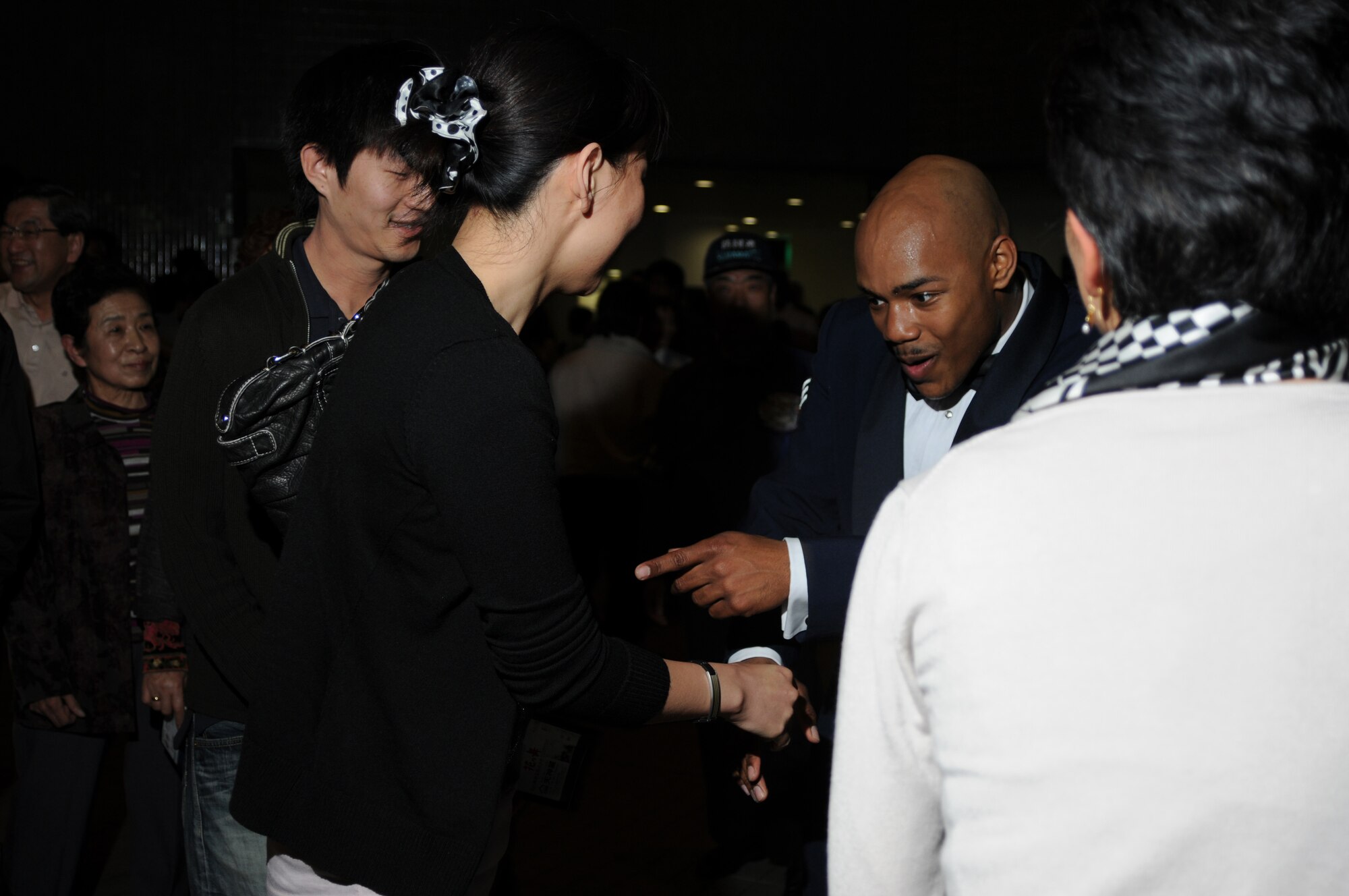 HAMAMATSU CITY, Japan -- Senior Airman Andrew Jones, U.S. Air Force Band of the Pacific-Asia, talks with fans April 18 following a performance here. The show was the first stop on the band's week-long tour throughout southern Japan. The band enhances goodwill and furthers mutual respect for cultural differences between the citizens of Japan and the United States by performing numerous concerts in the Japanese community. (U.S. Air Force photo/Tech. Sgt. Kimberly Spinner)
