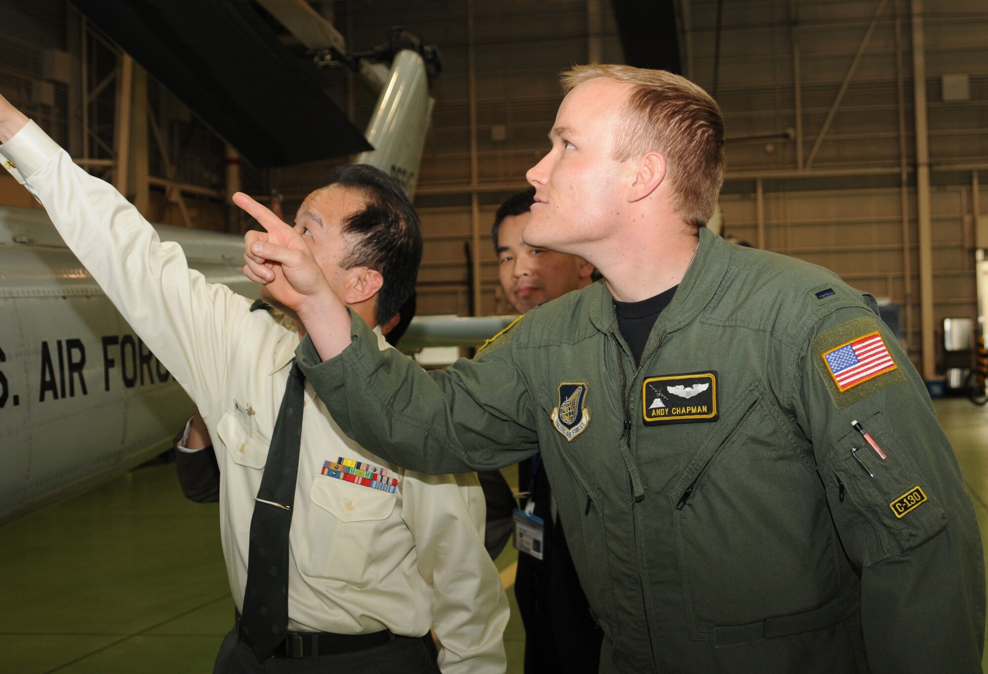 YOKOTA AIR BASE, Japan-- 1st Lt. Andy Chapman, 36th Airlift Squadron, briefs faculty and students from The National Institute for Defense Studies, Japan, April 23 on the base's mission and capabilities during a tour of the base. While most of the tour participants were from the Japan Self-Defense Forces, the militaries of France, India, Thailand and the U.S. were represented as well as Japanese civilians who work closely with the military. The purpose of the tour was to deepen the understanding and mission of U.S. Forces Japan in providing security in the Asia and Pacific region. (U.S. Air Force photo/Airman Sean Martin)