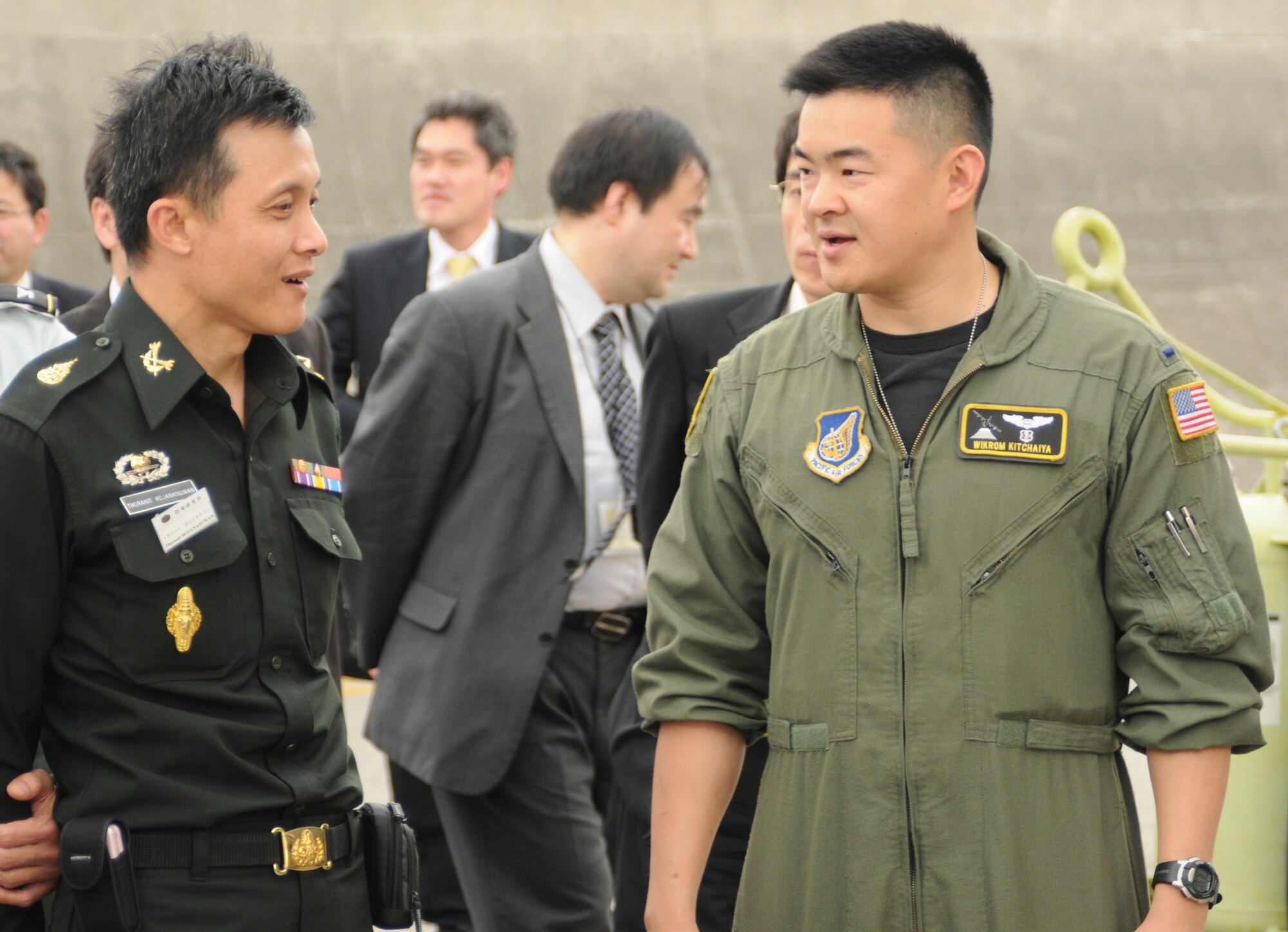 YOKOTA AIR BASE, Japan-- 1st Lt. Wikrom Kitchaiya, 36th Airlift Squadron, (right) briefs Thai Army Col. Thoranit Rojanasuwan, a student at The National Institute for Defense Studies, Japan, April 23 on the squadron's mission and capabilities during a tour of the base flightline. While most of the tour participants were from the Japan Self-Defense Forces, the militaries of France, India, Thailand and the U.S. were represented as well as Japanese civilians who work closely with the military. The purpose of the tour was to deepen the understanding and mission of U.S. Forces Japan in providing security in the Asia and Pacific region. (U.S. Air Force photo/Airman Sean Martin)