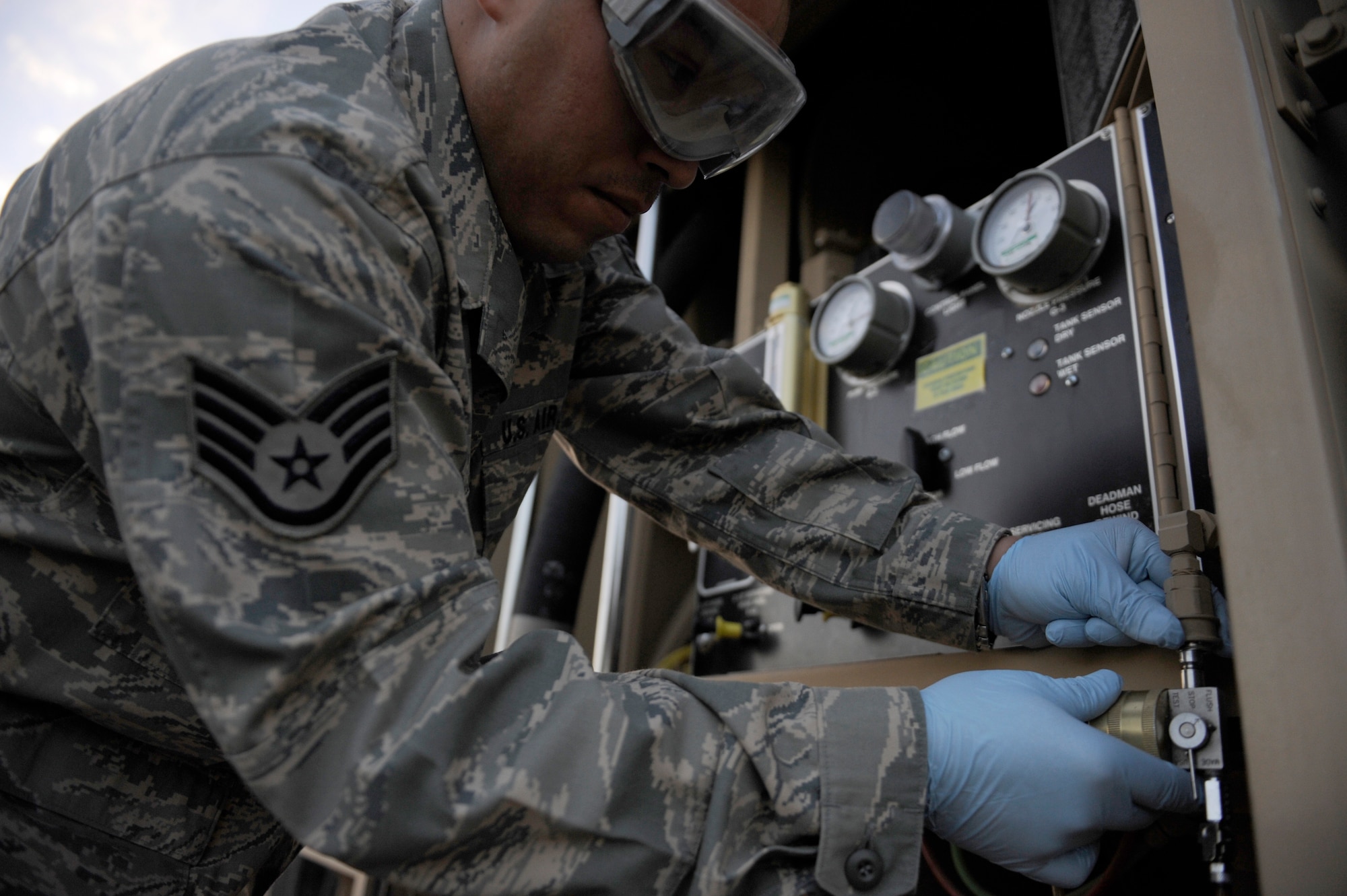 Staff Sgt. Jayson Torres, 380th Expeditionary Logistics Readiness Squadron, fuels lab technician, samples a fuel from an R-11 fuel truck for solids and water, April 4 at an undisclosed location in Southwest Asia. Sergeant Torres is deployed from Eglin AFB, Fla. and hails from Lubbock, Texas. (U.S. Air Force photo by Senior Airman Brian J. Ellis) (Released)