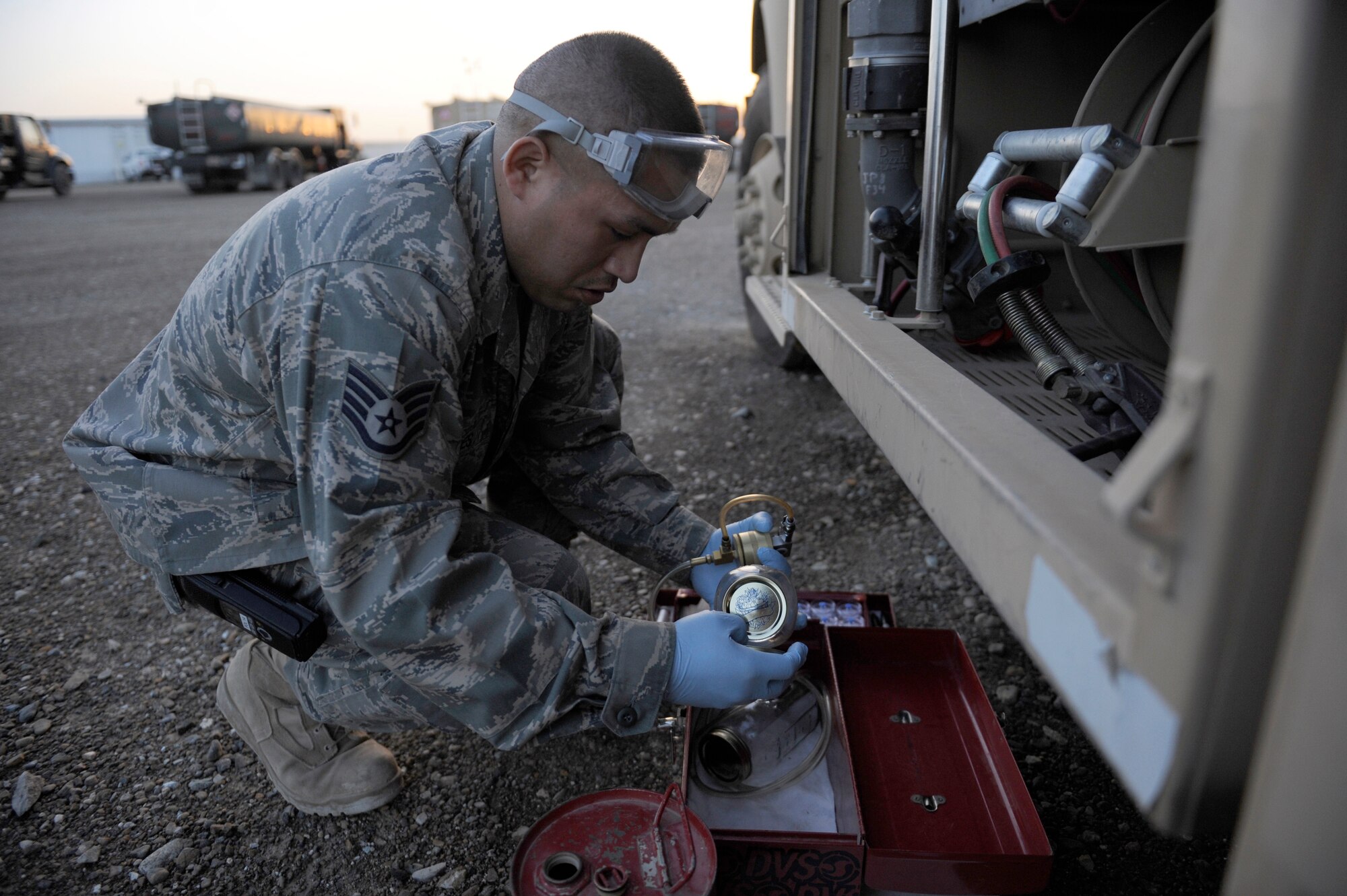 Staff Sgt. Jayson Torres, 380th Expeditionary Logistics Readiness Squadron, fuels lab technician, samples a fuel from an R-11 fuel truck for solids and water, April 4 at an undisclosed location in Southwest Asia. Sergeant Torres is deployed from Eglin AFB, Fla. and hails from Lubbock, Texas. (U.S. Air Force photo by Senior Airman Brian J. Ellis) (Released)