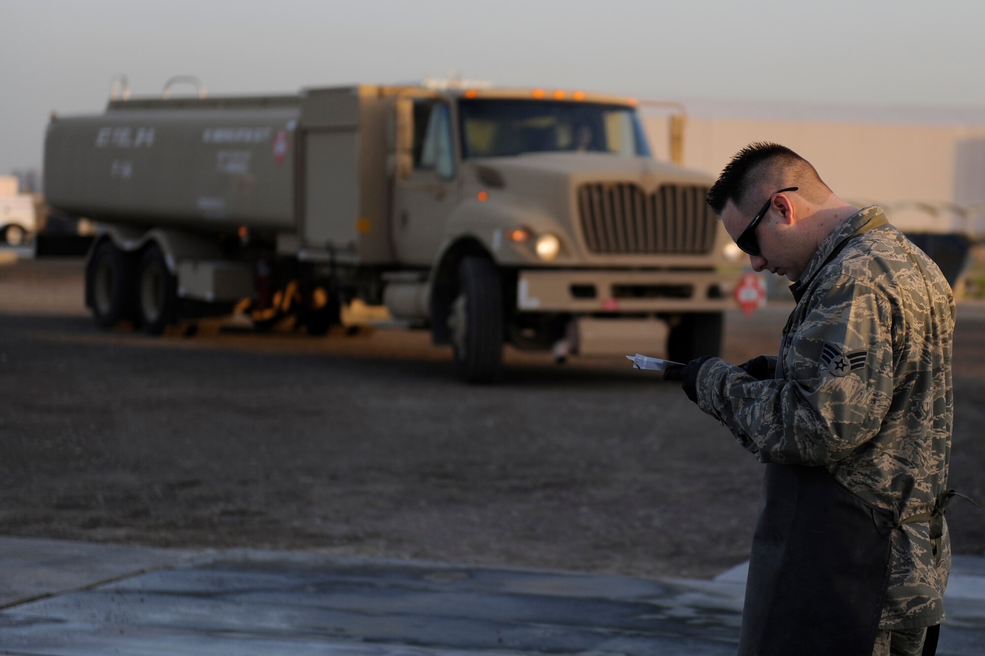 Senior Airman Brian Amos, 380th Expeditionary Logistics Readiness Squadron, fuels flight, reviews his C-man checklist prior to a fuel checkpoint operation on an R-11 fuel truck at an undisclosed location in Southwest Asia, April 4. Airman Amos is deployed from Nellis AFB, Nev. and hails from Las Vegas, Nev. (U.S. Air Force photo by Senior Airman Brian J. Ellis) (Released)