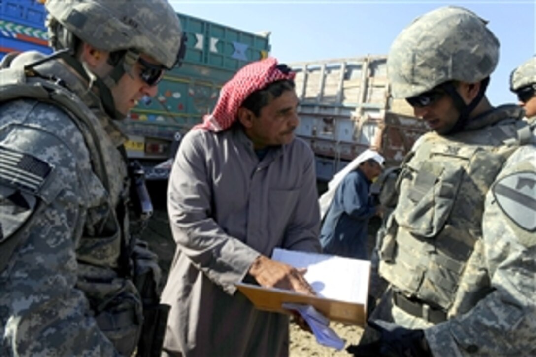 U.S. Army 1st Lt. Nicholas Rinaldi and an Iraqi interpreter speak with an Iraqi citizen while on a dismounted patrol through the Al Uruba district of Mosul, Iraq, April 20, 2009. Rinaldi is assigned to the 1st Cavalry Division.