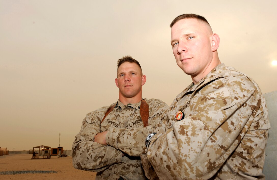 Staff Sgt. Robert I. Johnson (right) air mobility chief, Movement Control Center-Kuwait and Sgt. Tracey R. Johnson motor transport chief, Military Police Company, 1st Battalion, 12th Marine Regiment are twin brothers and Albany, La. natives enjoying a brief reunion on Camp Virginia, Kuwait, April 23. Robert is currently deployed to Kuwait and Tracey was on his way back to the states from a seven-month deployment in Iraq.::r::::n::