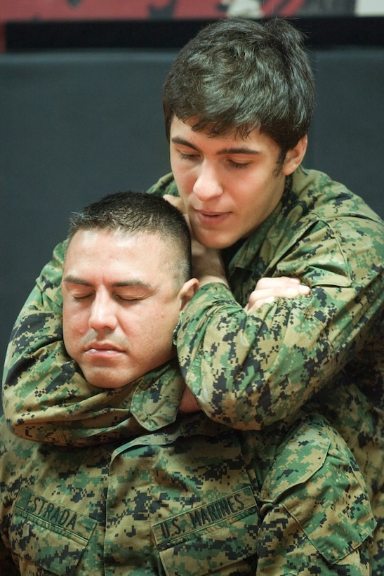 Christain Uflacker demonstrates a choke hold during a recent demonstration of Brazilian Jiu-Jitsu on Camp Johnson April 27.