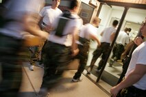 Marine Officer Candidates rush into a classroom prior to a class during an Officer Candidate School Preparation weekend at Camp Dodge, Des Moines, Iowa,  April 24. The OCS Prep weekend is designed to give candidates a glimpse into what OCS life is like.