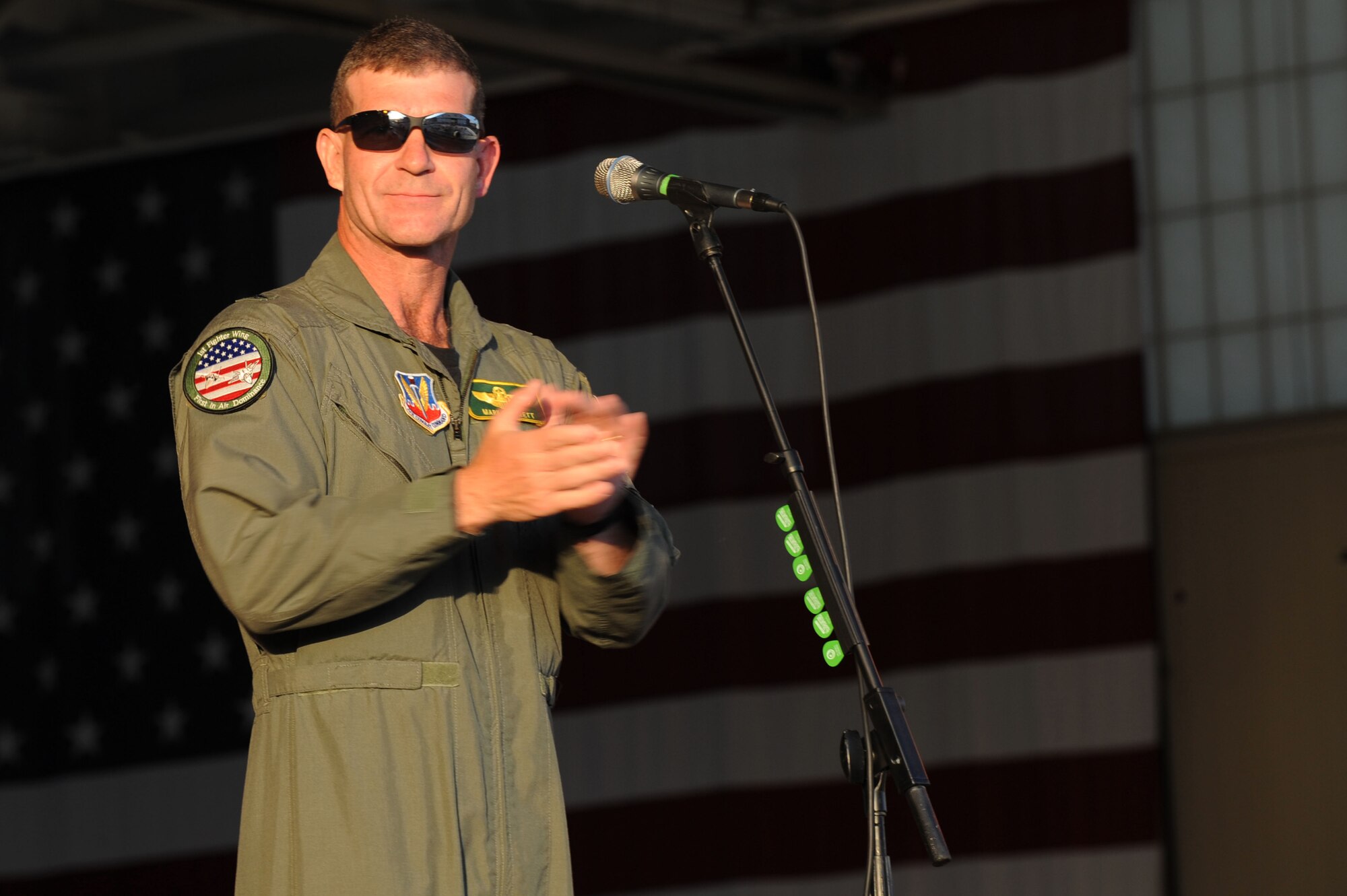 LANGLEY AIR FORCE BASE, Va. -- Brig. Gen. Mark A. Barrett, 1st Fighter Wing commander, gives the opening speech before the Kentucky Head Hunters began their concert during AirPower over Hampton Roads April 24. The first evening of the open house kicked off with a live concert from the country band, followed by a night air show and fireworks. (U.S. Air Force photo/Senior Airman Ashley Hawkins)