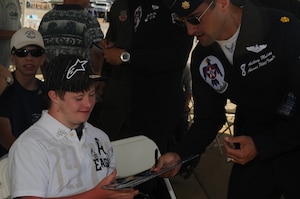 LANGLEY AIR FORCE BASE, Va. -- Maj. Tony Mulhare, Thunderbirds advance pilot and narrator, talks to Harris Fischer, Air Force JROTC member and Special Olympics participant, after the Thunderbirds' demonstration during AirPower over Hampton Roads April 24. The open house is a free event featuring a variety of aerial demonstrations, including historical aircraft and the latest fighter jet, the F-22A Raptor. (U.S. Air Force photo/Senior Airman Ashley Hawkins)
