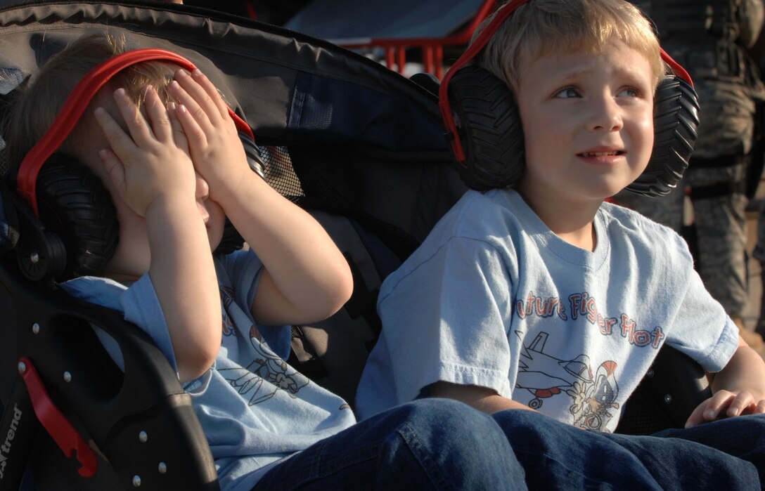 LANGLEY AIR FORCE BASE, Va. -- Brayden and Bryant Green, watch the U.S. Air Force Heritage Flight as the F-4 flies in formation with today's top war-fighting jets, the F-15C Eagle and F-22A Raptor April 24.  Langley's open house is an annual event that helps educate the public, increase recruiting and show appreciation to the local community. (U.S. Air Force photo/Senior Airman Cecil C. McCloud)