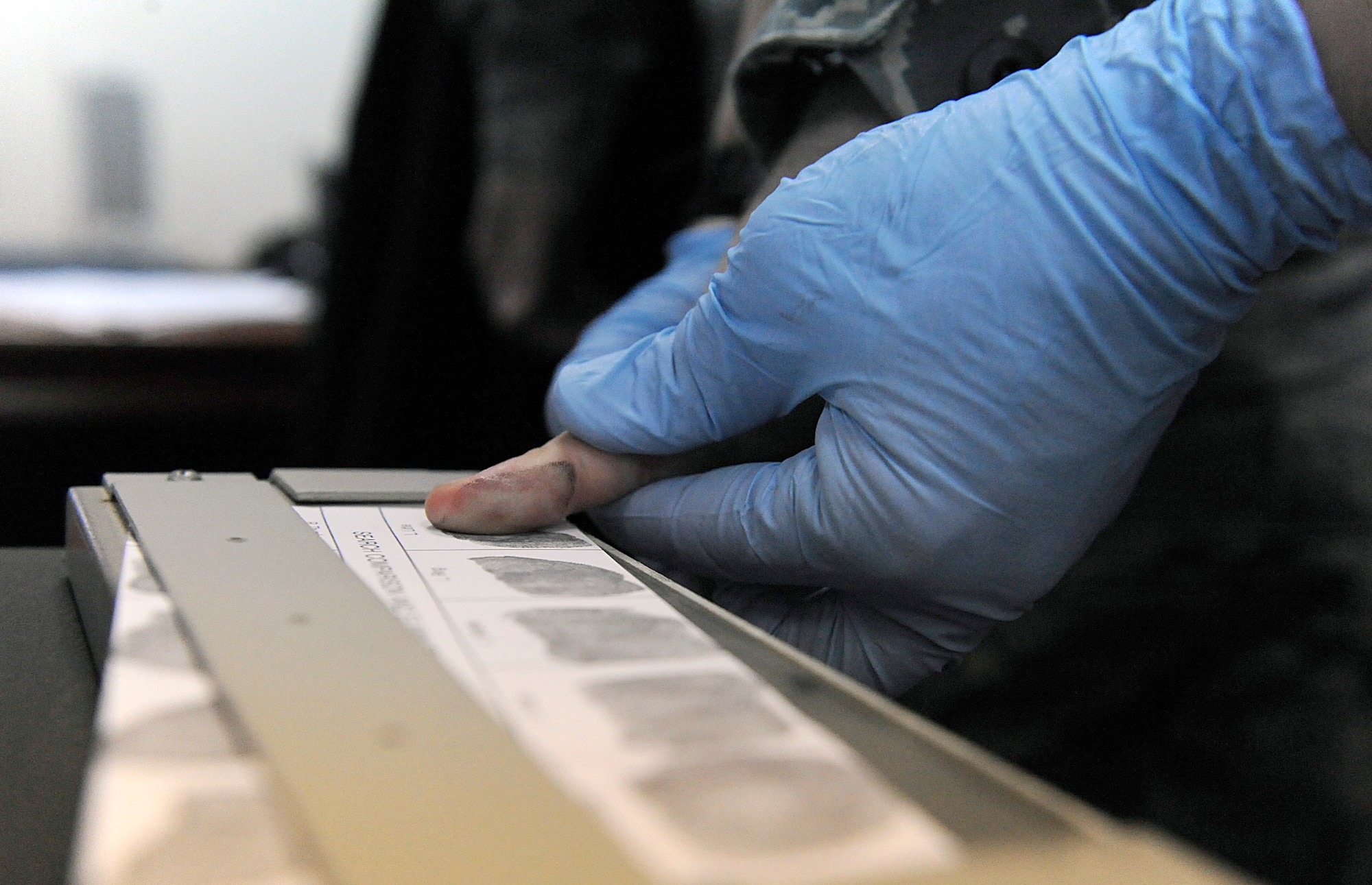 A "suspect" gets fingerprinted during a mock investigation April 11 at the 380th Air Expeditionary Wing in Southwest Asia. Prints were taken from a glass and were against the ones taken from "suspects" to determine who was involved with the "crime." (U.S. Air Force photo/Senior Airman Brian J. Ellis)
