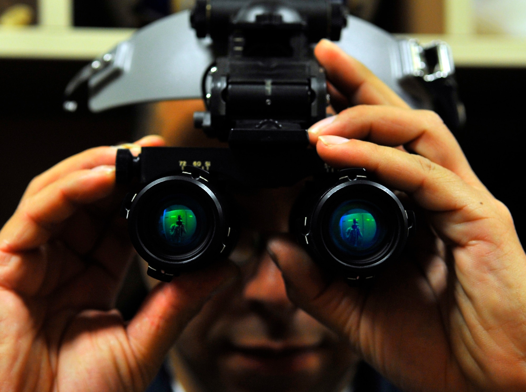 EIELSON AIR FORCE BASE, ALASKA -- Petty Officer 2nd Class Joseph Villarreal inspects a pair of night vision goggles for scratches on the lenses and to ensure it has free movements during RED FLAG-Alaska Apr. 23. RF-A is a Pacific Air Forces-directed field training exercise for U.S. and coalition forces flown under simulated air-combat conditions. PO2 Villarreal is an aviation life support equipment technician assigned to the Naval Air Station Whidbey Island, Wash. (U.S. Air Force photo/Senior Airman Christopher Boitz)