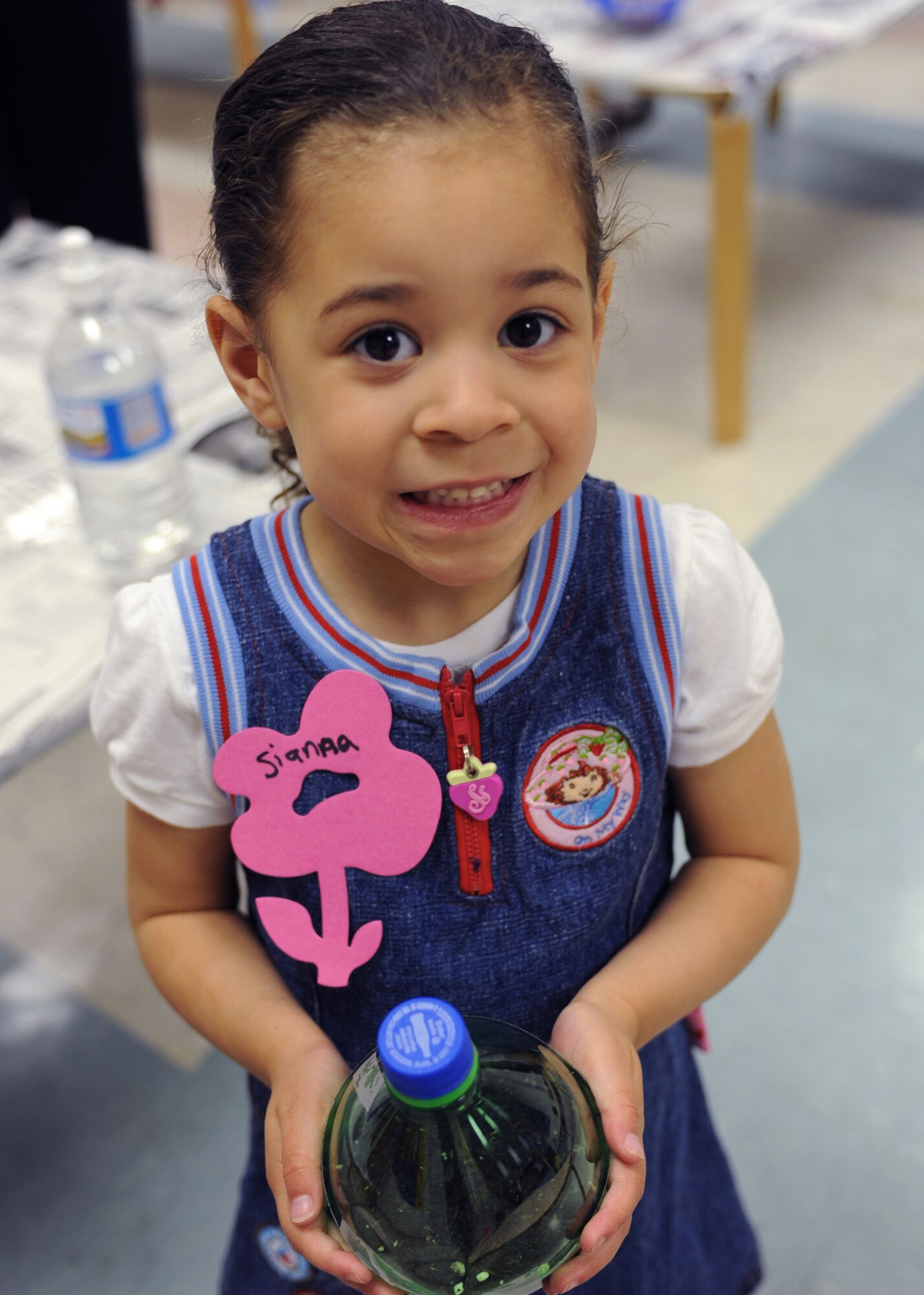 CANNON AIR FORCE BASE, N.M. -- Sianna Coleman displays the potted plant she created at the Clovis Carter Library, April 23. Children listened to stories about how to be friendly to the environment and planted seeds using recycled materials. (U.S. Air Force Photo/Airman 1st Class Evelyn Chavez) 