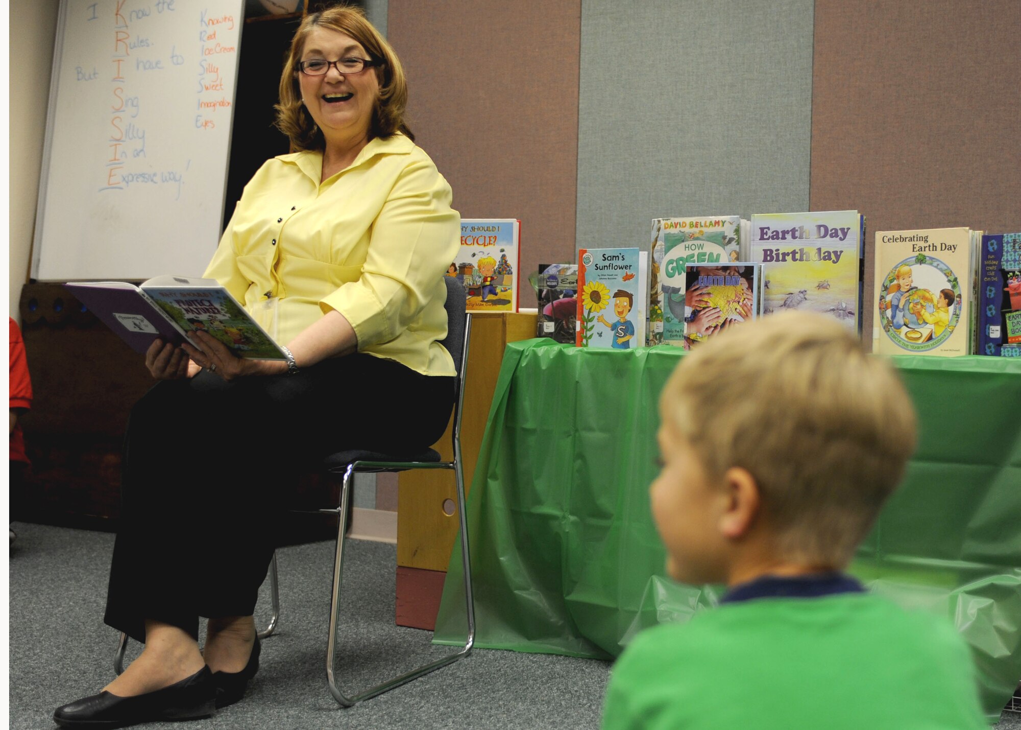 CANNON AIR FORCE BASE, N.M. -- Vera Wood, 27th Special Operations Civil Engineer Squadron, reads to children at Clovis Carter Library stories about being environmentally friendly April 23. This was one of the many events hosted by the base Cannon April 16-23 to celebrate Earth Day and Arbor Day. (U.S. Air Force Photo/Airman 1st Class Evelyn Chavez) 