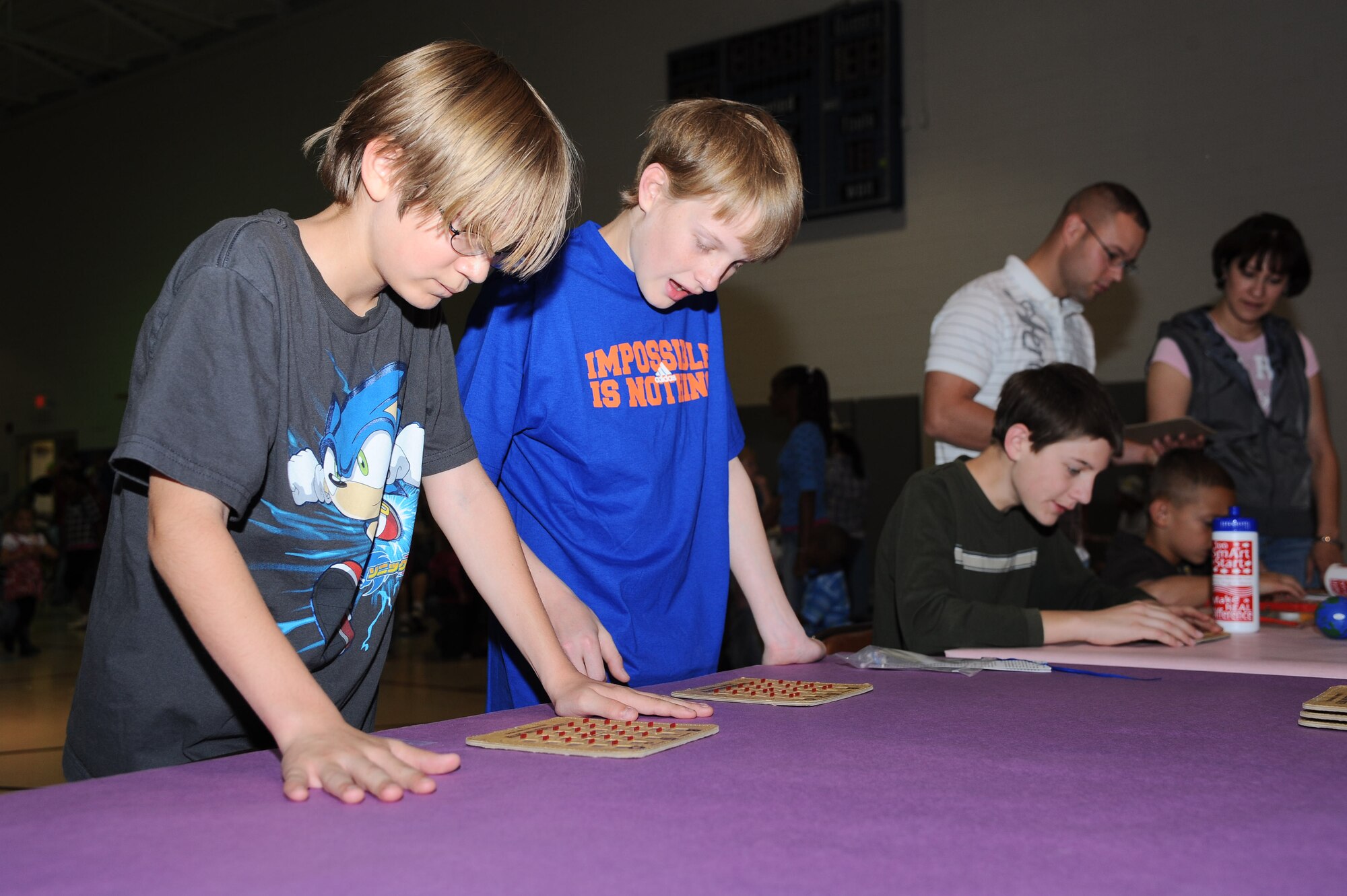 Children play a game of bingo at the Holloman Kids Carnival at the Youth and Teens Center, April 18. The Kids Carnival offered many forms of entertainment for the youth of all ages. (U.S Air Force photo/ Airman 1st Class DeAndre Curtiss)