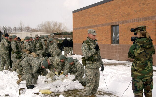27 March 2009
Staff Sgt Amber Monio interviews Captain Charles Moore who finds his troops now not only helping the people of Moorhead Minnesota but also trying to keep the water out of the Armory. Over a hundred members of the Guard are currently calling the armory home sleeping on cots night and day while taking shifts to "fight" the flood of 2009 in Moorhead.
U.S. Air Force Photo by Tech Sgt Erik Gudmundson (Released)

