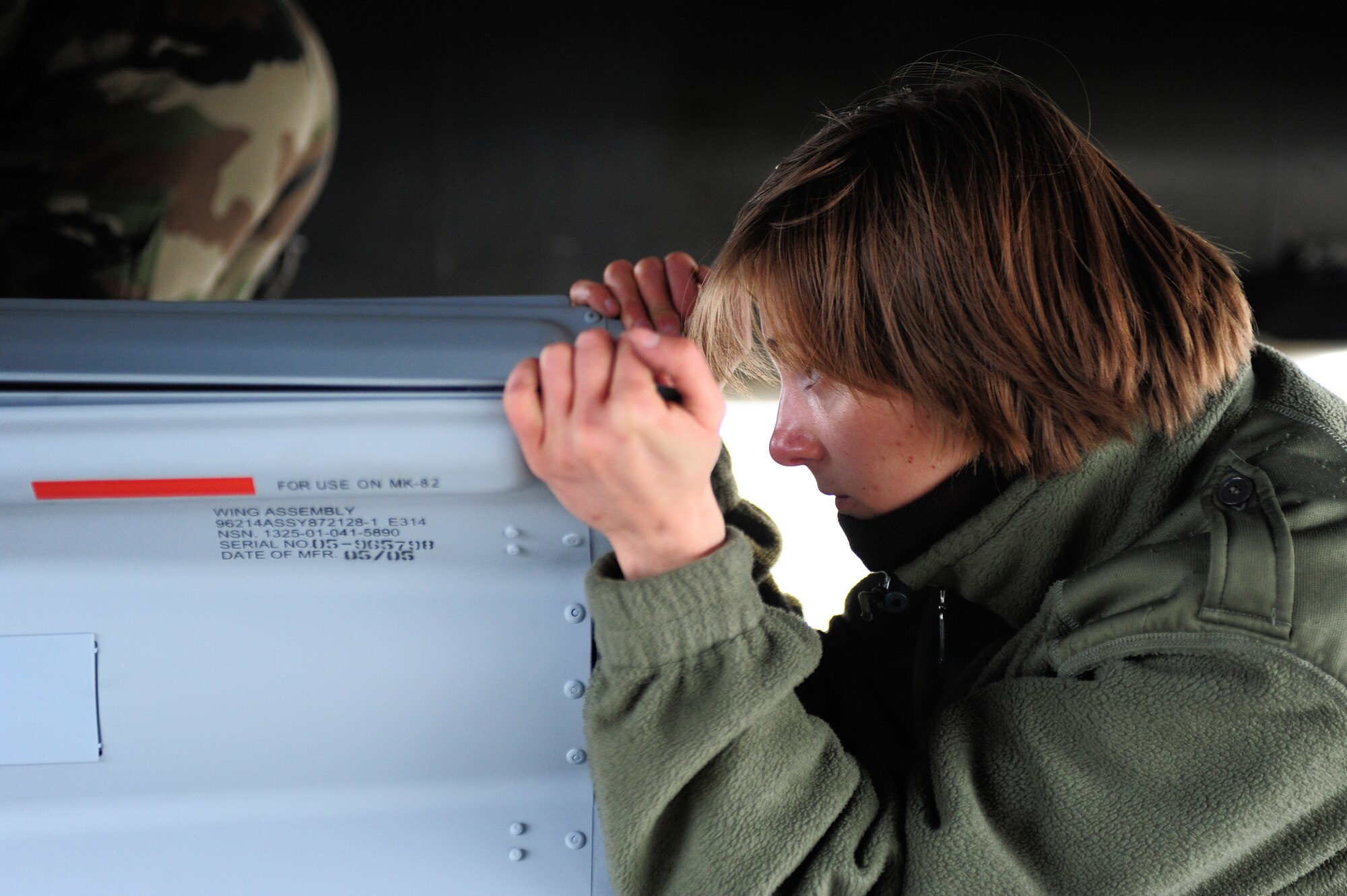 Sgt. Amandine Thevenov, French Air Force, guides a practice Guided Bomb Unit-28 into place while being loaded onto a French Dassault M2000 Mirage during RED FLAG-Alaska 09-2 April 22, 2009, Eielson Air Force Base, Alaska. This exercise provides training for deployed maintenance support personnel in sustainment of large-force deployed air operations.  (U.S. Air Force Photo/Senior Airman Jonathan Snyder)
