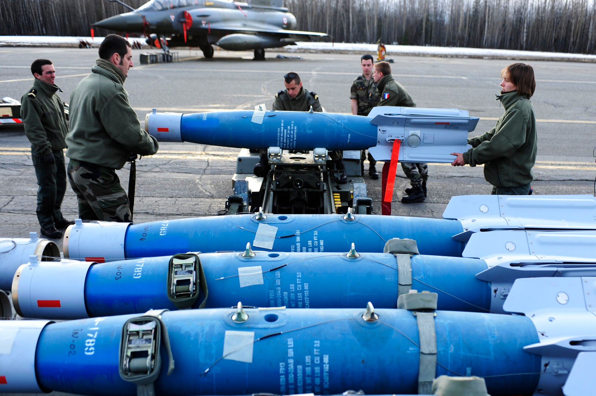 French Air Force maintainers prepare to transport a practice Guided Bomb Unit-28 to a French Dassault M2000 Mirage during RED FLAG-Alaska 09-2 April 22, 2009, Eielson Air Force Base, Alaska. The practice bombs are the same weight as the real bombs giving maintenance personnel a sense of realism.  (U.S. Air Force Photo/Senior Airman Jonathan Snyder)
