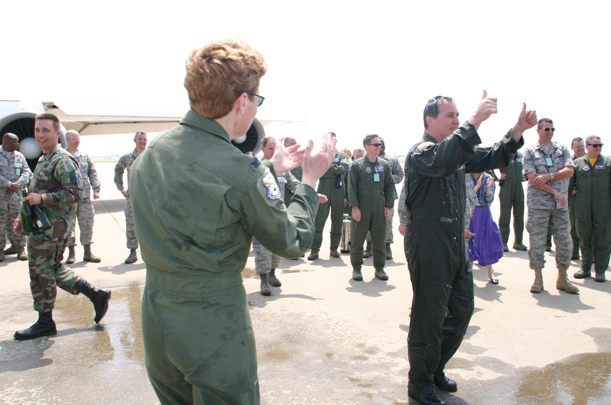 Col. Pat Hoffman, commander, 552nd Air Control Wing, applauds Col. Joseph Rossacci, out-going vice commander, 552 ACW, for a job well done. (Air Force Photo by 1Lt Kinder Blacke)