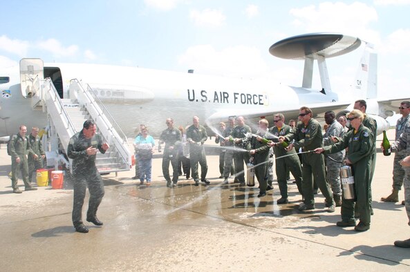 In true 552nd Air Control Wing tradition, friends, family and co-workers soaked Col. Joseph Rossacci, out-going vice commander, 552 ACW, as he disembarked after his final flight on the E-3 Sentry during his assignment here. (Air Force Photo by 1Lt Kinder Blacke)