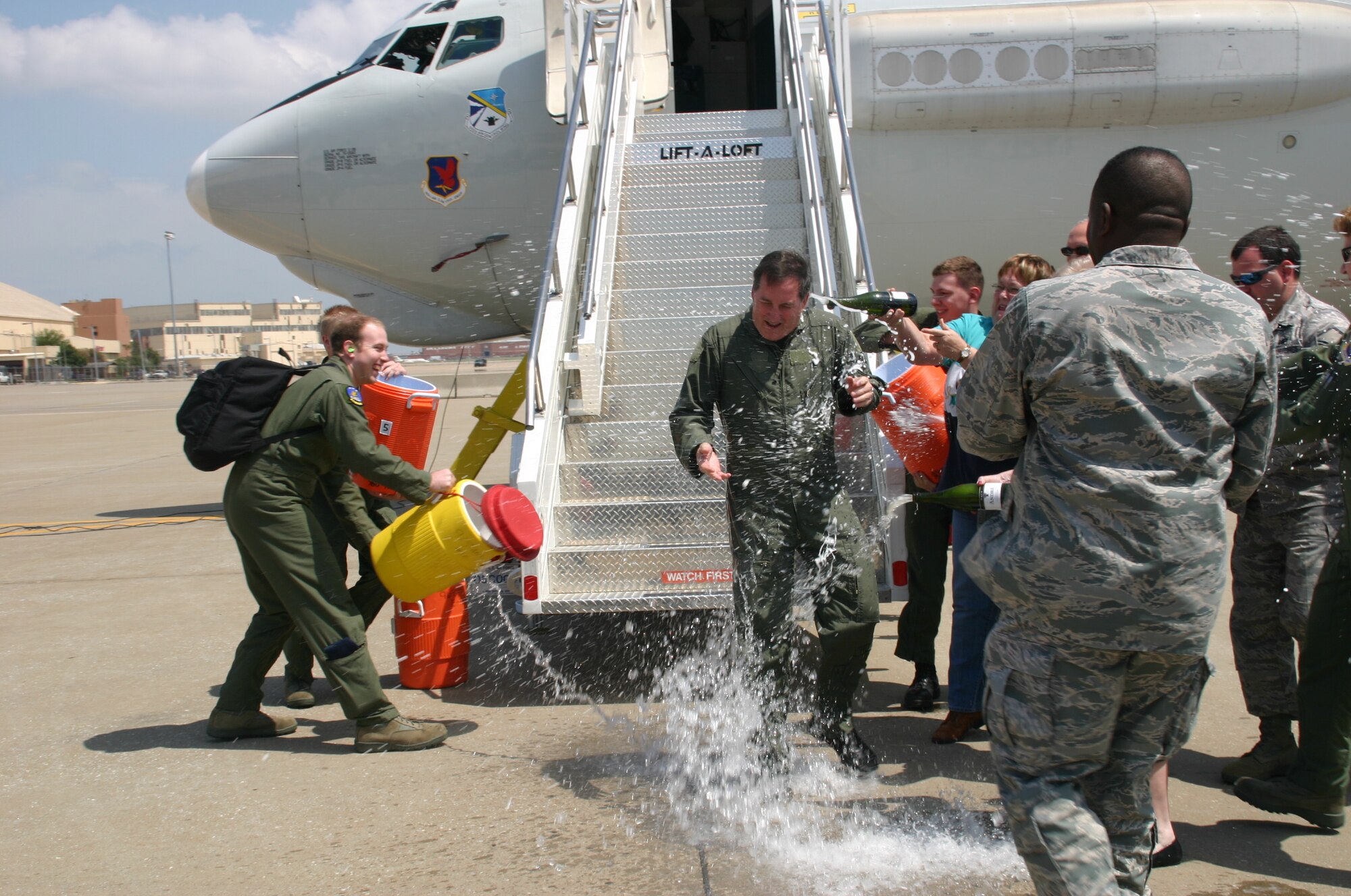 As Col. Joseph Rossacci, vice commander, 552nd Air Control Wing, stepped off the jet, he was soaked with champagne and water as part of the celebration of his final flight on the E-3 Sentry during his assignment here. (Air Force Photo by 1Lt Kinder Blacke)