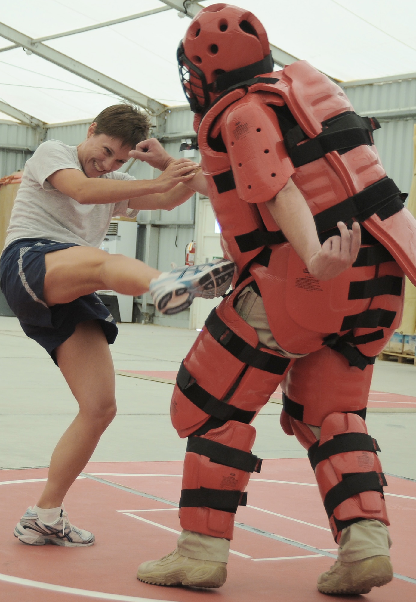 Master Sgt. Malinda Kingsley fights off the "red man attacker" played by contractor Rick Baldwin during self-defense training April 18 at an air base in Southwest Asia. The sexual assault response coordinator sponsored the training that gave students the chance to learn techniques to defend themselves from attack. Sergeant Kingley is with the 380th Expeditionary Maintenance Squadron, and is deployed from Grand Forks Air Force Base, N.D. (U.S. Air Force photo/Senior Airman Brian J. Ellis)
