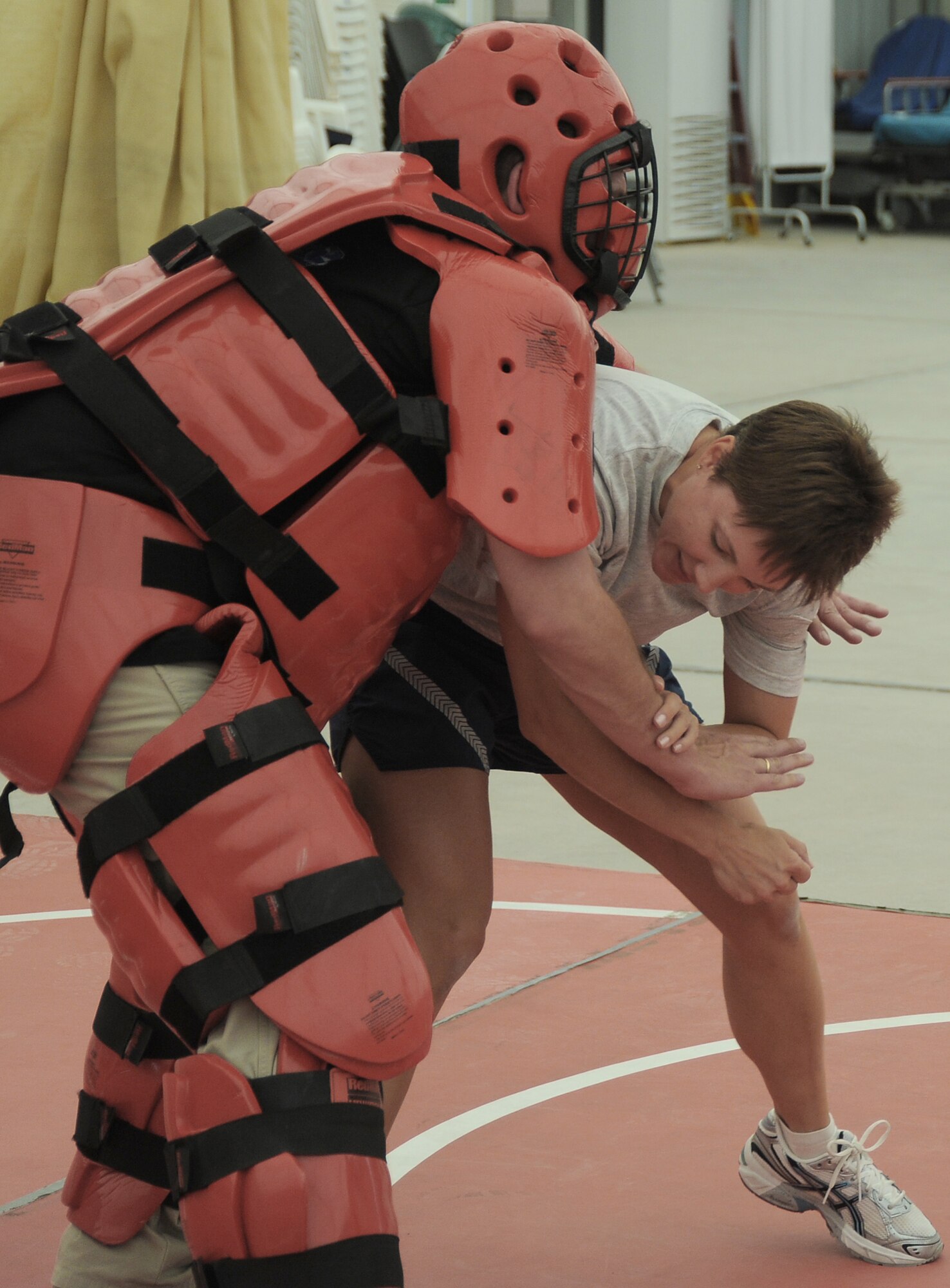 Master Sgt. Malinda Kingsley fights off the "red man attacker" played by contractor Rick Baldwin during self-defense training April 18 at an air base in Southwest Asia. Sergeant Kingsley is from the 380th Expeditionary Maintenance Squadron and is deployed from Grand Forks Air Force Base, N.D. (U.S. Air Force photo/Senior Airman Brian J. Ellis)
