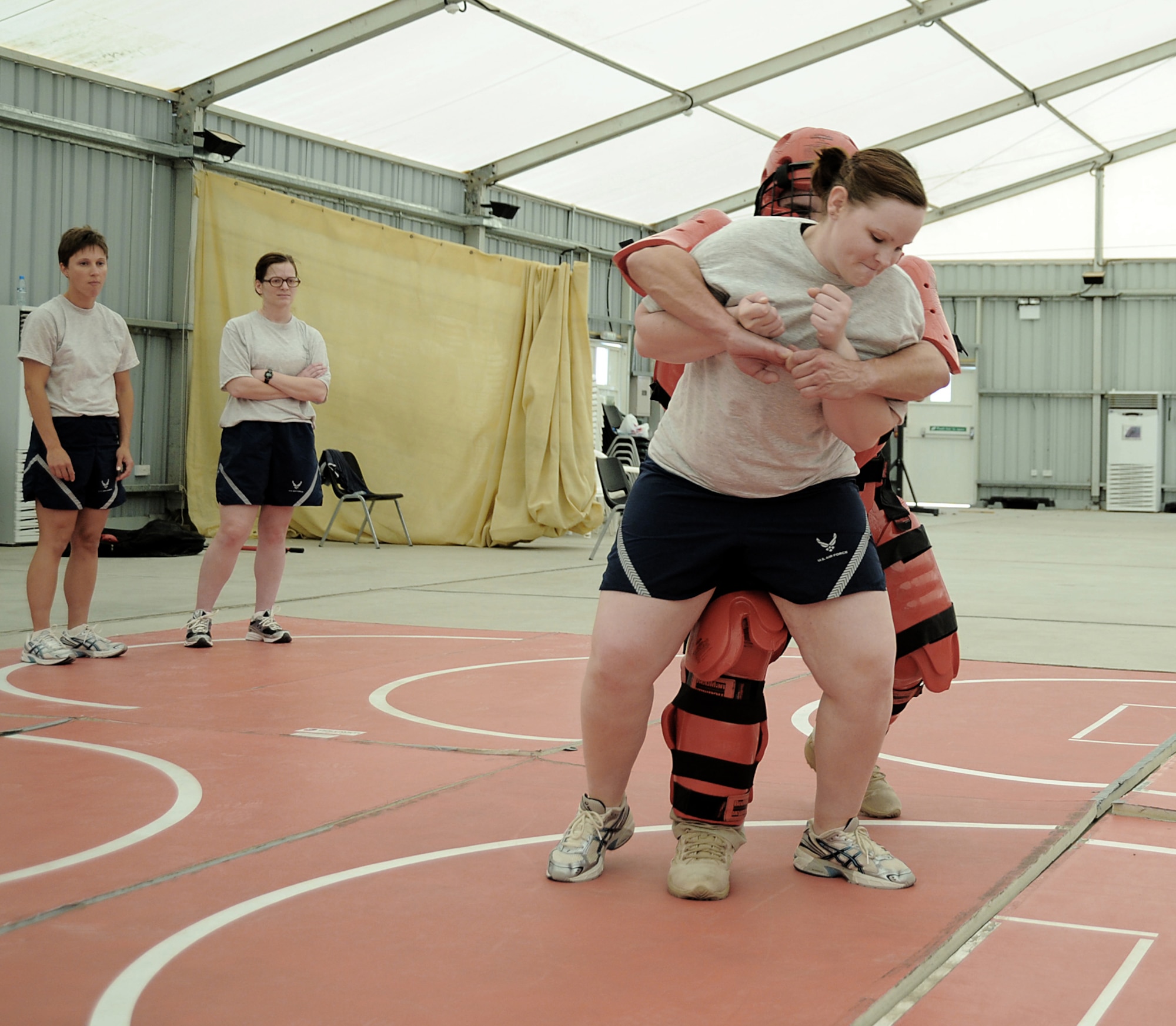 Airman 1st Class Amanda Dunaway fights off the "red man attacker" played by contractor Rick Baldwin during self-defense training April 18 at an air base in Southwest Asia. The sexual assault response coordinator sponsored the training that gave students the chance to learn techniques to defend themselves from attack. Airman Dunaway is assigned to the 380th Expeditionary Security Forces Squadron, and deployed from Tinker Air Force Base, Okla. (U.S. Air Force photo/Senior Airman Brian J. Ellis)