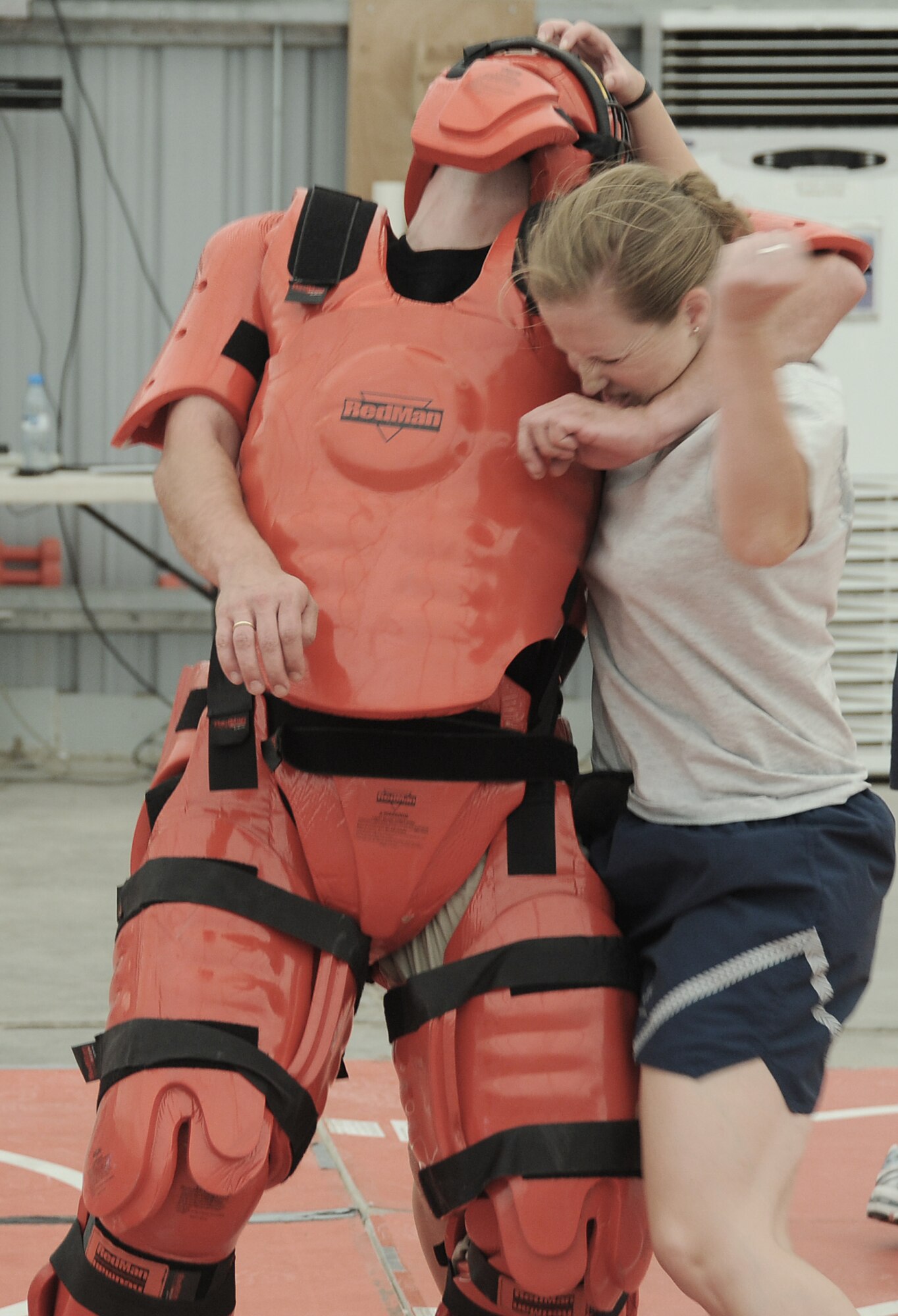Capt. Jennifer Pearson prepares to strike the "red man attacker" played by contractor Rick Baldwin during self-defense training April 18 at an air base in Southwest Asia. Captain Pearson is the public affairs officer for the 380th Air Expeditionary Wing, and deployed from Langley Air Force Base, Va. (U.S. Air Force photo/Senior Airman Brian J. Ellis)