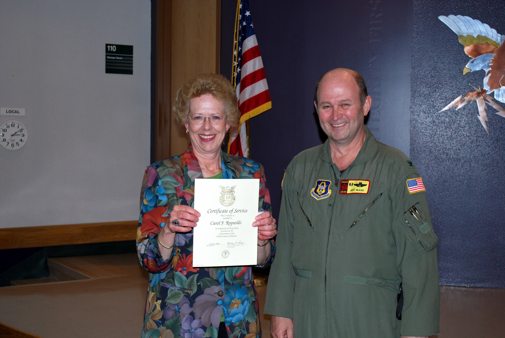 Mrs. Carol Reynolds holds up her 40 year civil service certificate presented to her by Col. Jeffery R. Glass, 507th Air Refueling Wing commander.  Mrs. Reynolds is the commander's secretary.