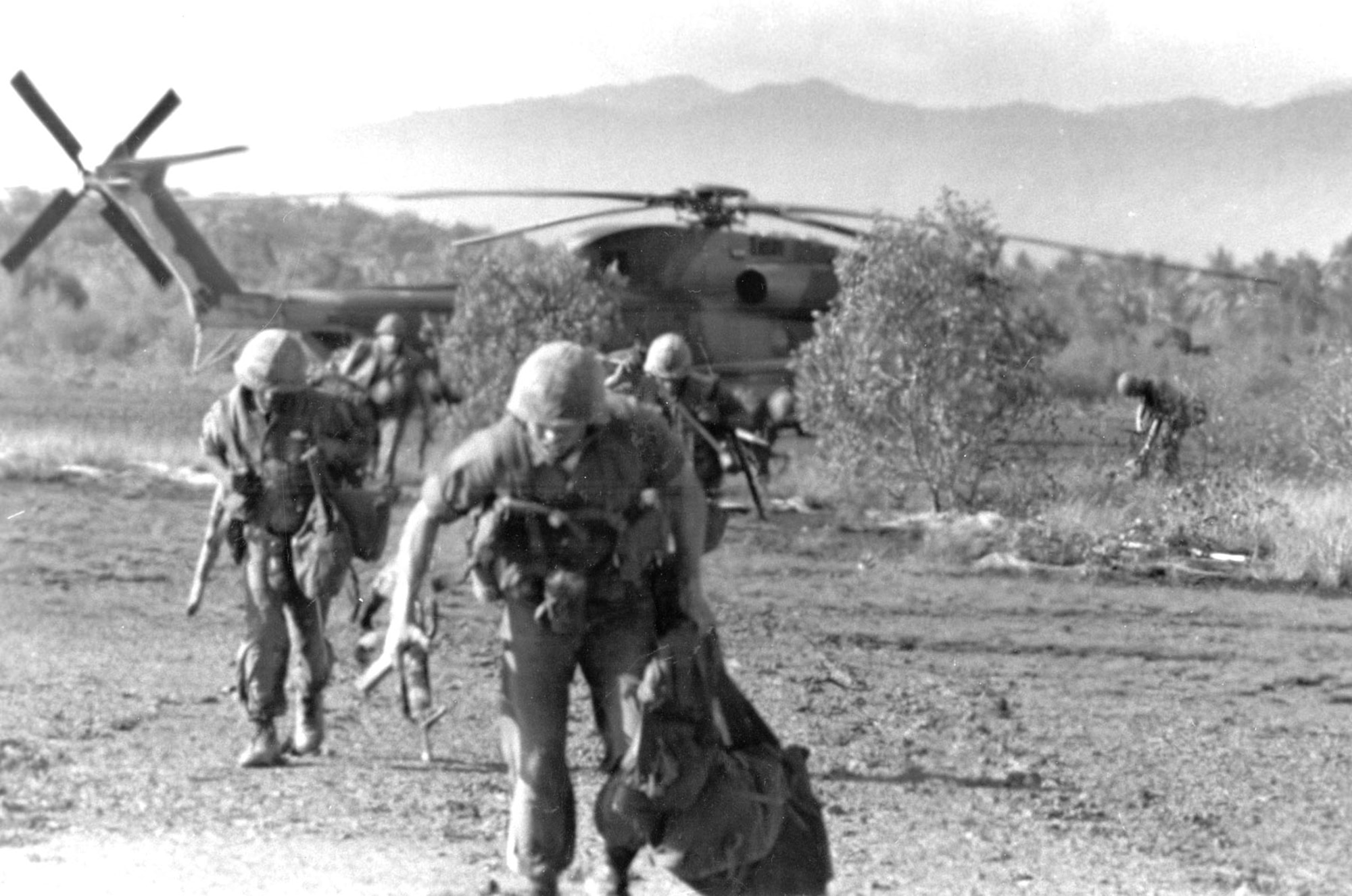 Unidentified U.S. Marines run from a CH-53 helicopter during the SS Mayaguez operation. (U.S. Air Force photo)