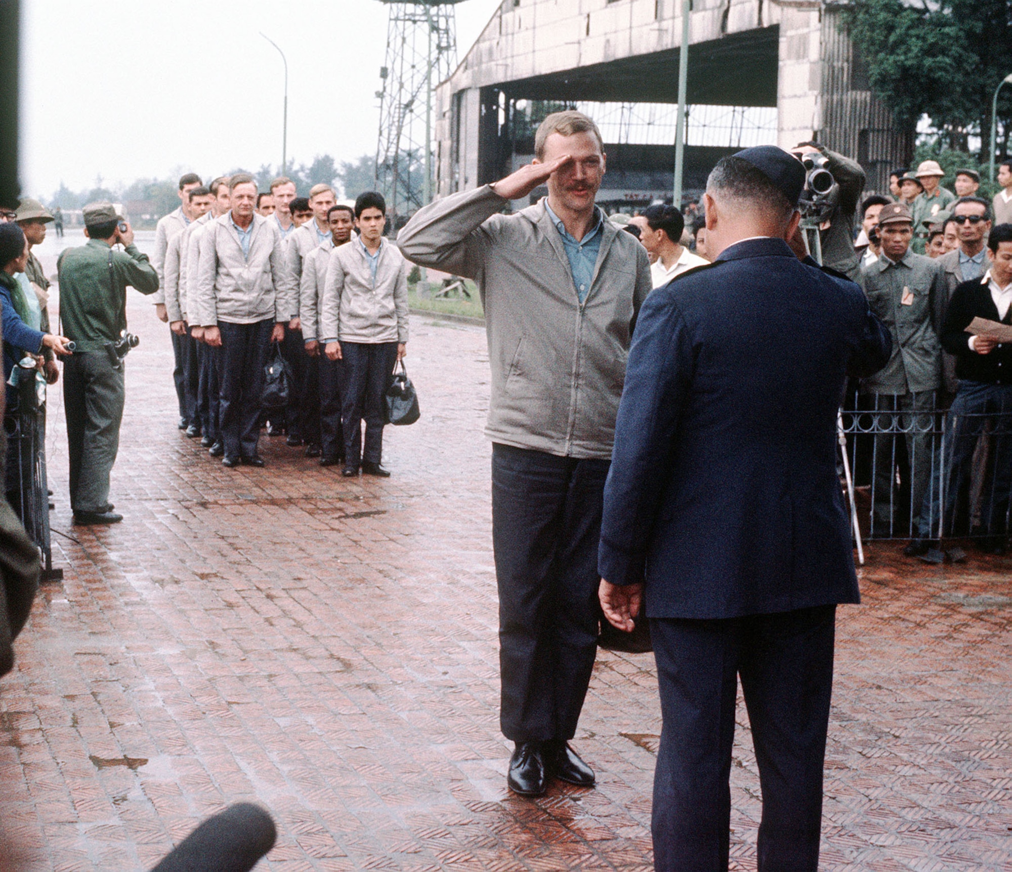 POWs regained their freedom and displayed proud military bearing, arriving at Gia Lam Airport in formation. Here, USAF Capt. Robert Parsels salutes as he is returned to U.S. military control. (U.S. Air Force photo)