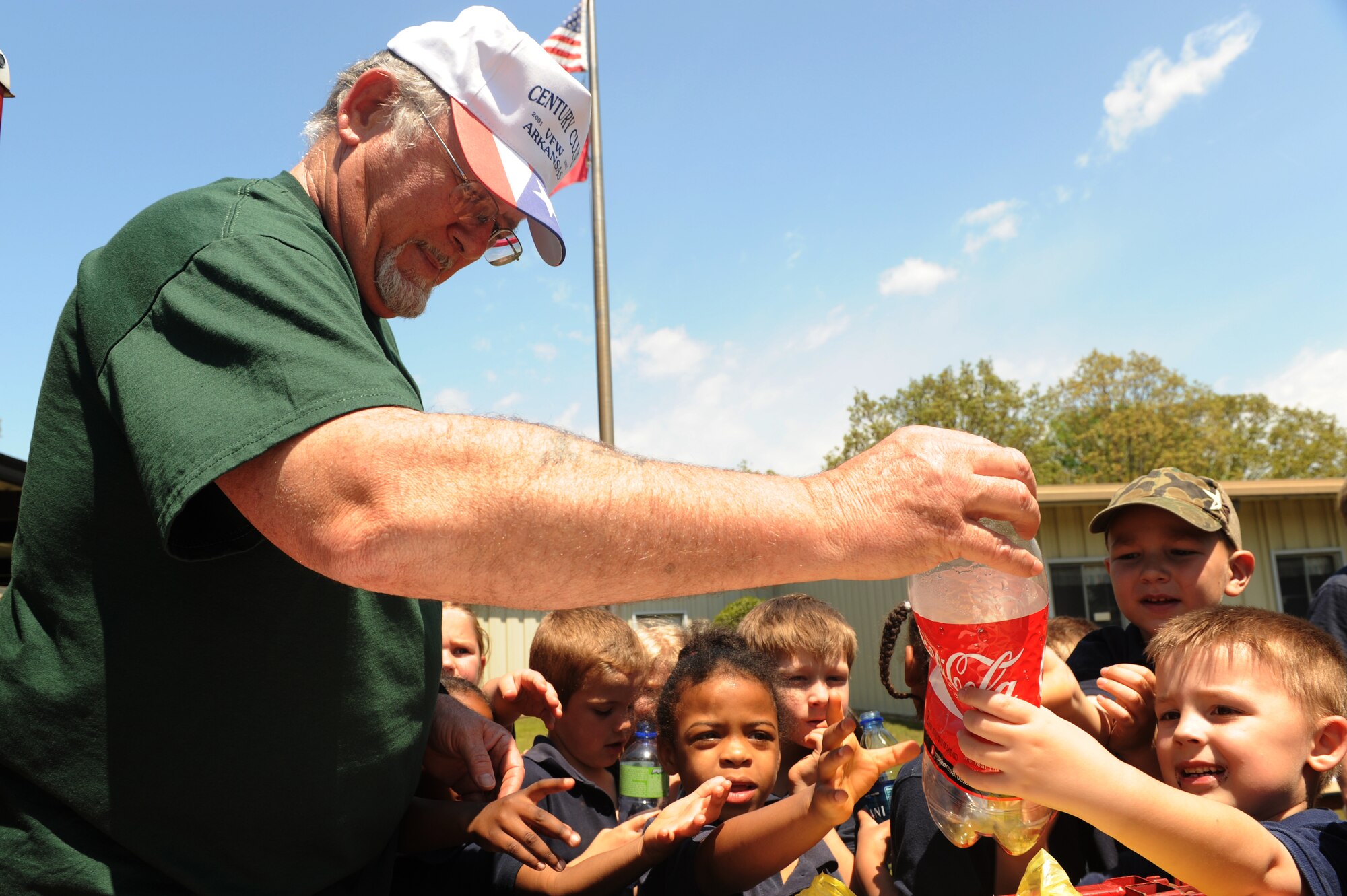 Mr. Wally Garron, Little Rock Air Force Base recycling warehouse manager, teaches students how to recycle bottles and cans during Earth Day at Arnold Elementary School April 22, 2009. During Earth Day, the students of Arnold were instructed on the importance of recycling and its effect on the environment as well as how to be respectful and aware of dangerous animals in the wild. (U.S. Air Force photo by Senior Airman Jim Araos)