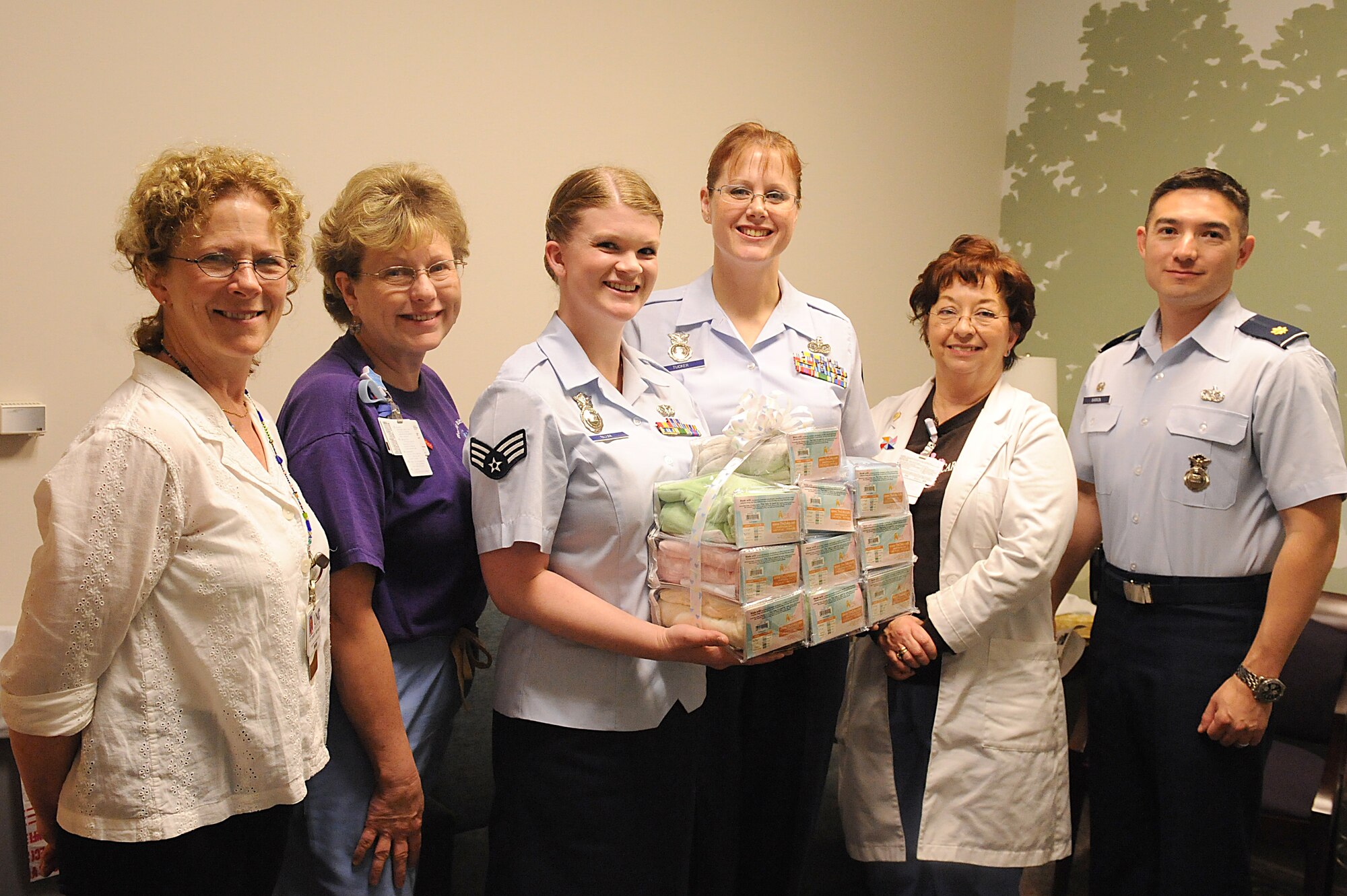 The 4th Security Forces Squadron pose with staff from the University of North Carolina Hospital in Chapel Hill, N.C. April 15, 2009. Squadron members donated 41 ergonomic pillows used to comfort premature babies in the hospital. The donation drive was held in memory of the daughter of Senior Airman Kerri Blum (3rd to the left), who died after 37 days of hospitalized care. (U.S. Air Force photo by Whitney S. Lambert)