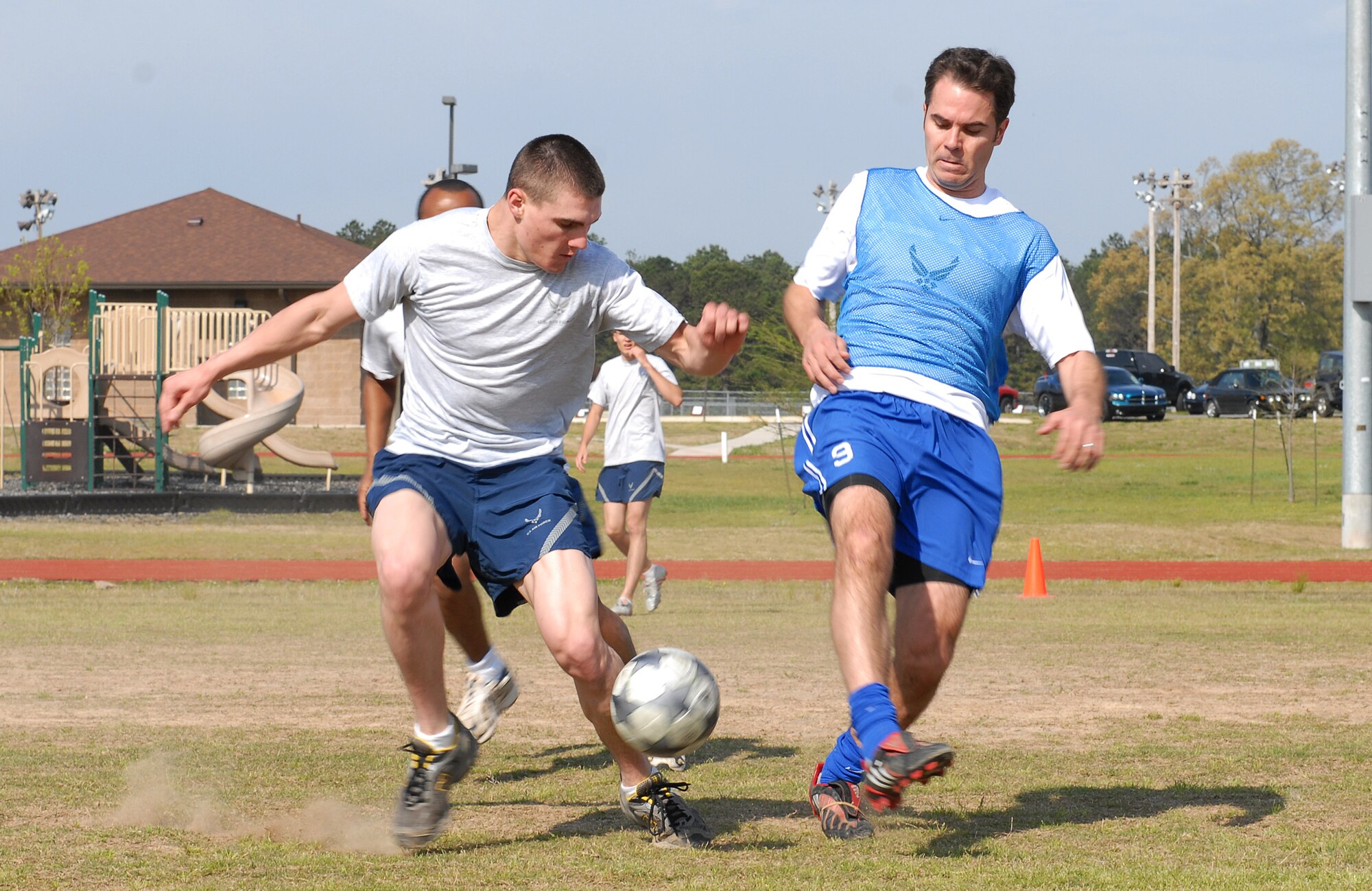 Amn Darwyn Case of the 19th Civil Engineer Squadron, battles for the ball with Maj. Gabriel Lurvey of the 19th Medical Group during the Little Rock Air Force Base “Fit to Fight Sports Day” soccer tournament  April 17, 2009. The Little Rock AFB Sports Day is a biannual event designed to celebrate fitness and increase the morale of personnel stationed here. (U.S. Air Force photo by Senior Airman Lausanne Pacheco)
