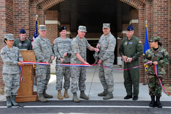 Maj. Gen. Winfield W. Scott III, 18th Air Force commander, and Col. Greg Otey, 19th Airlift Wing commander, prepare to cut the ribbon to the new 19th Maintenance and Operations Group building at Little Rock Air Force Base April 16, 2009. Joining General Scott and Colonel Otey are, from left, Col. Chris Hair, 19th Maintenance Group commander, Col. Donald Jackson, U.S. Army Corp of Engineers district engineer, and Col. Jeffrey Hoffer, 19th Operations Group commander. (U.S. Air Force photo/Senior Airman Steele Britton)