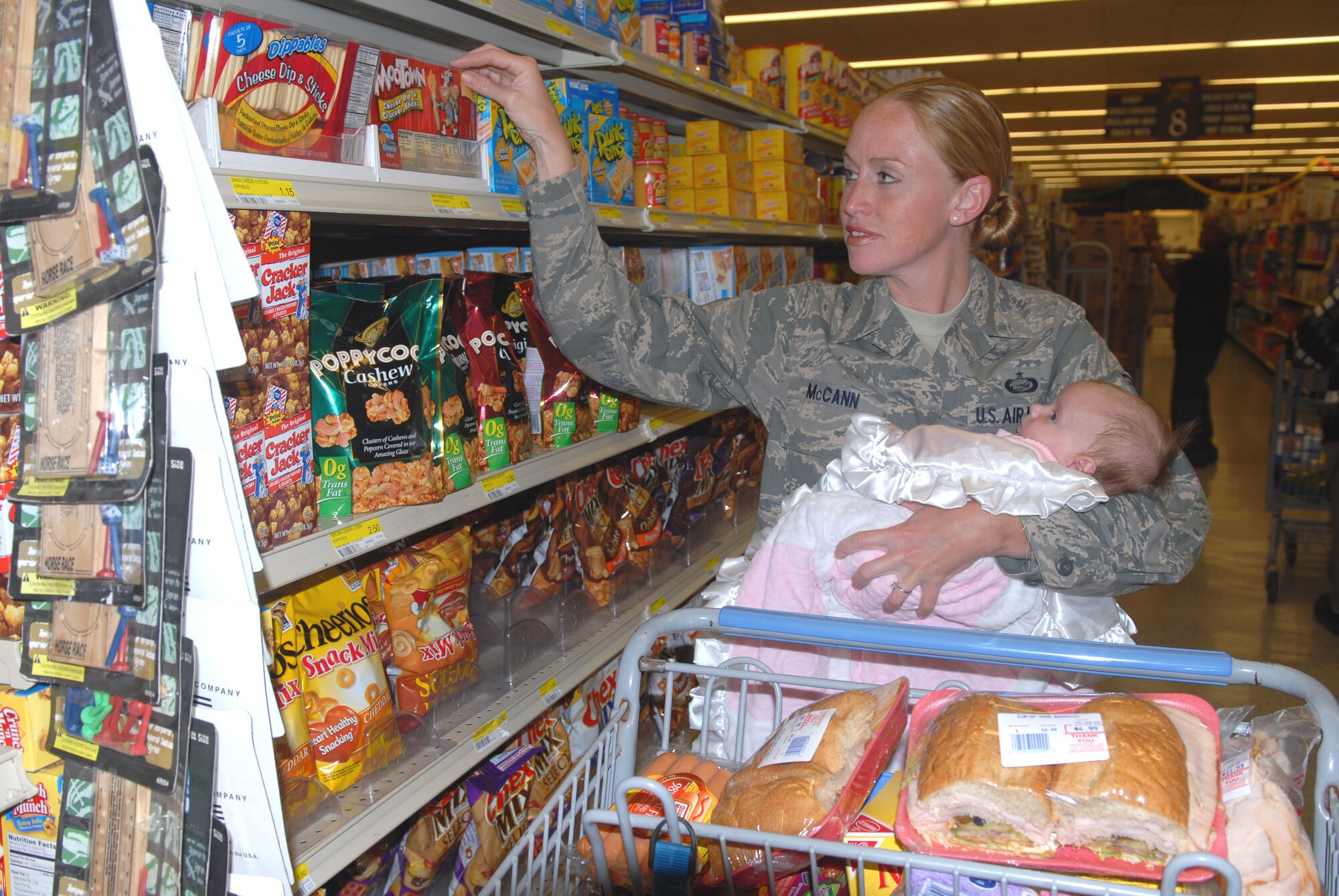 HICKAM AIR FORCE BASE, Hawaii – Staff Sgt, Shannon McCann, a member of the 15th Mission Support Squadron, shops with her daughter, Alyssandra Peirano, at the Hickam AFB Commissary April 23. Effective May 1, there will be a “no guests or visitors” policy at the Hickam AFB commissary in an effort to ensure military privileges are truly reserved for dependents of and members who wear or have worn a uniform in service to their country. (U.S. Air Force photo/Ed Foster)