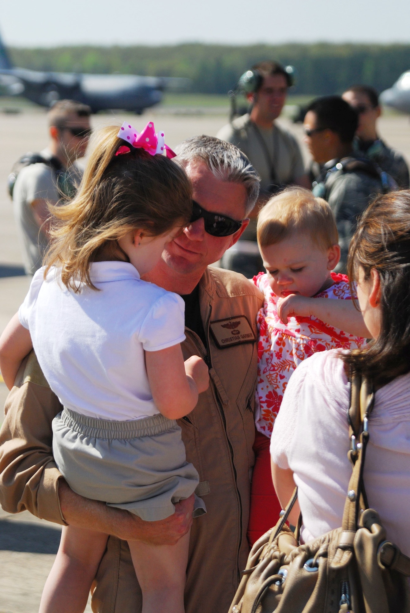 Maj. Christian Garber, a 41st Airlift Squadron pilot, meets with his children and wife following his return to Little Rock AFB from a deployment April 16, 2009. (U.S. Air Force photo by Staff Sgt. Juan Torres)
