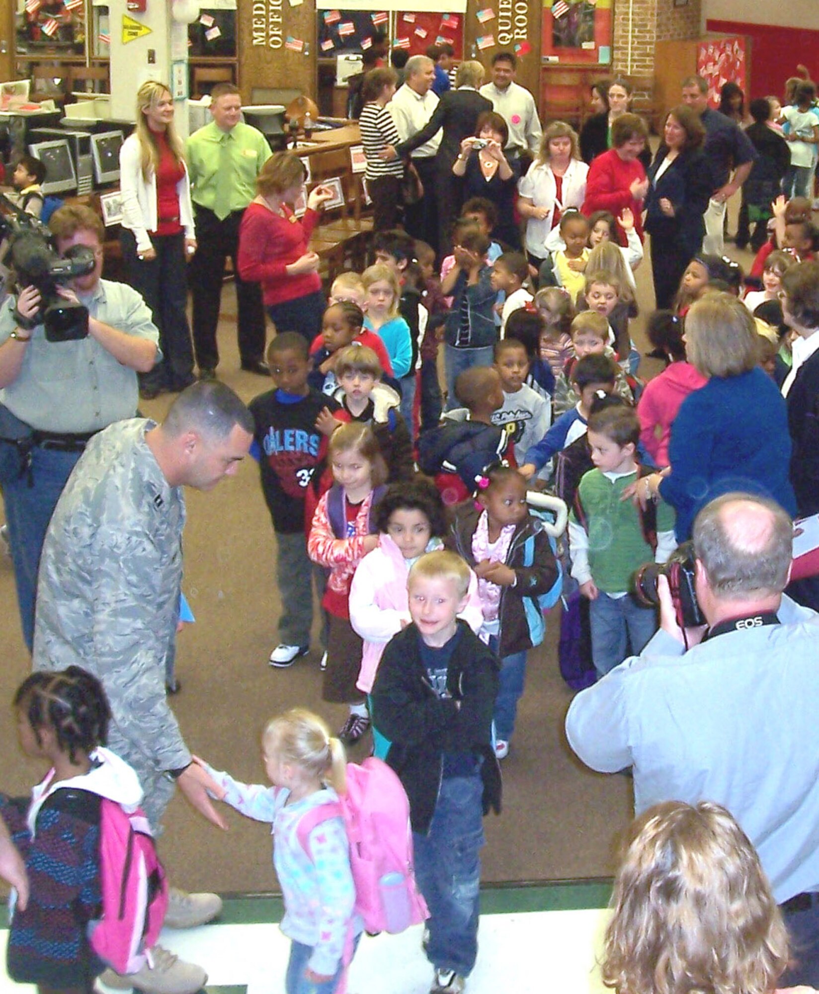Capt. Bill Pierce receives “high fives” from students at Wiley Post Elementary School during a send-off last month for his overseas deployment. Pierce works as an Assistant Principal at Wiley Post here in Oklahoma City,Oklahoma, and is the 507th Air Refueling Wing deputy public affairs officer. 