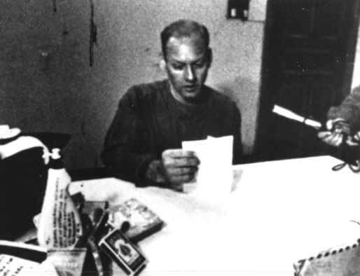 The North Vietnamese took every opportunity to exploit prisoners. Here, USAF Maj. Roger Ingvalson receives a rare Christmas letter—note the microphone on the right. Ingvalson’s wife died while he was a POW. (U.S. Air Force photo)