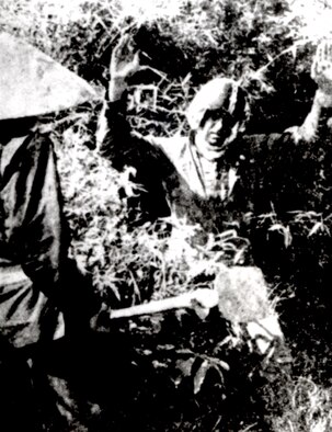This staged communist propaganda photo depicts a U.S. “pilot” captured by a local civilian. The man dressed as a pilot has never been identified. (U.S. Air Force photo)