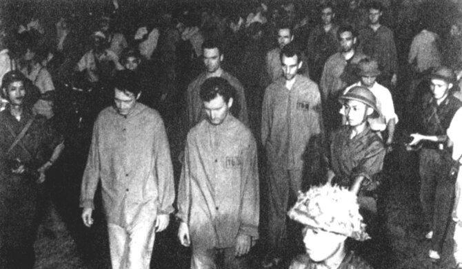 Prisoners were paraded before angry crowds in Hanoi, where loudspeakers blared insults and encouraged the crowd’s abuse. Many in the crowd attacked the POWs. Front row (l-r): Richard Kiern and Kile Berg; second row Robert Shumaker and “Smitty” Harris; third row Ronald Byrne and Lawrence Guarino. (U.S. Air Force photo)