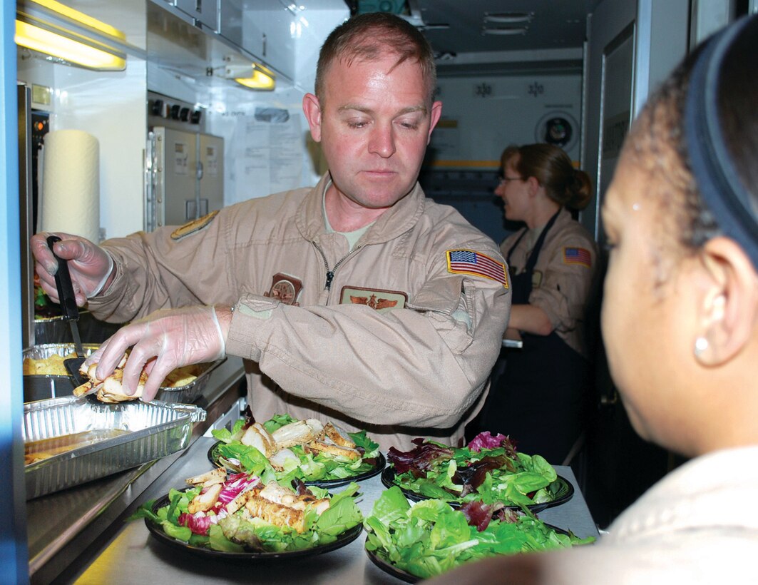Tech. Sgt. Chris Wilson, 89th Airlift Wing, Operations Support Squadron, prepares salads for passengers during a NATO mission headed to Iraq. (U.S. Air Force photo/ Major Bill Walsh)